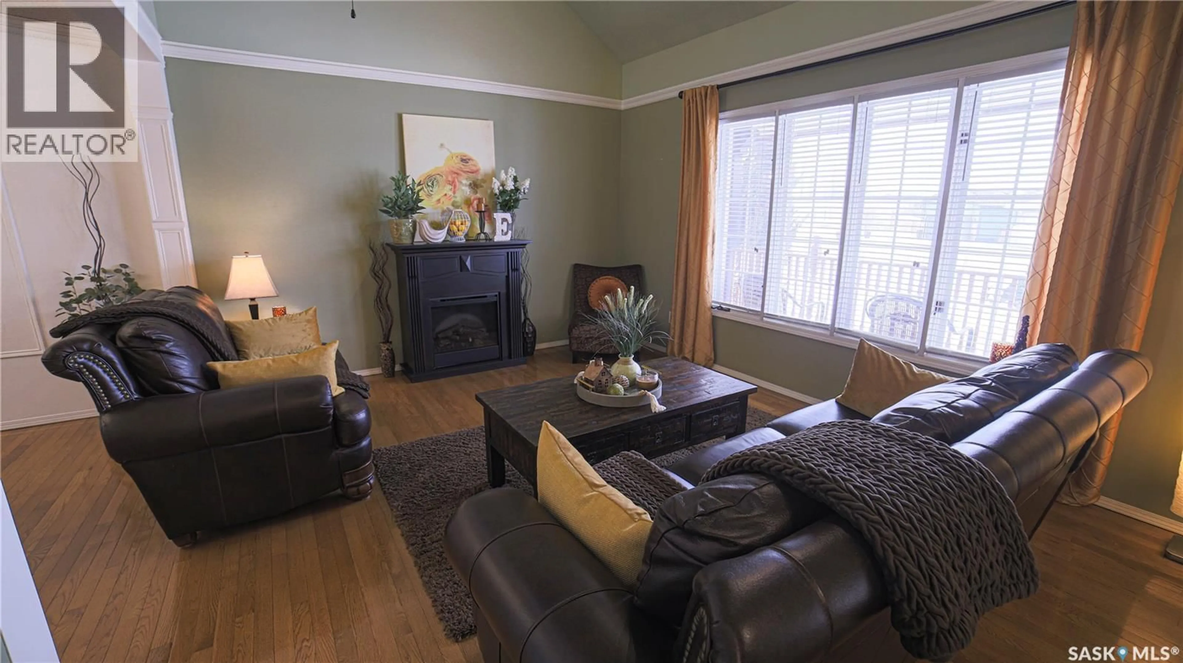 Living room with furniture, wood/laminate floor for 434 BROOKS ROAD, Estevan Saskatchewan S4A2P2