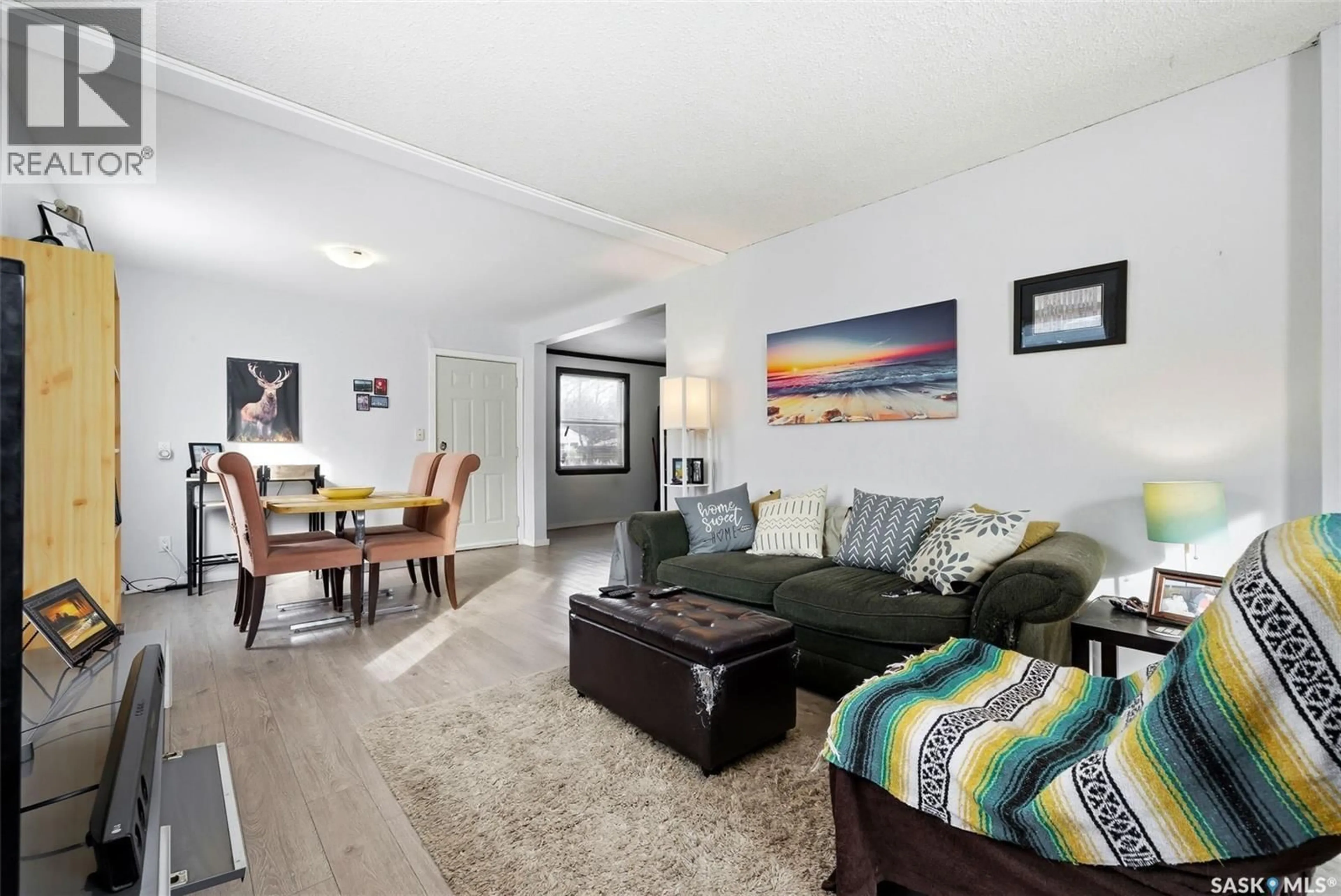 Living room with furniture, wood/laminate floor for 414 18TH AVENUE, Regina Saskatchewan S4N1G1