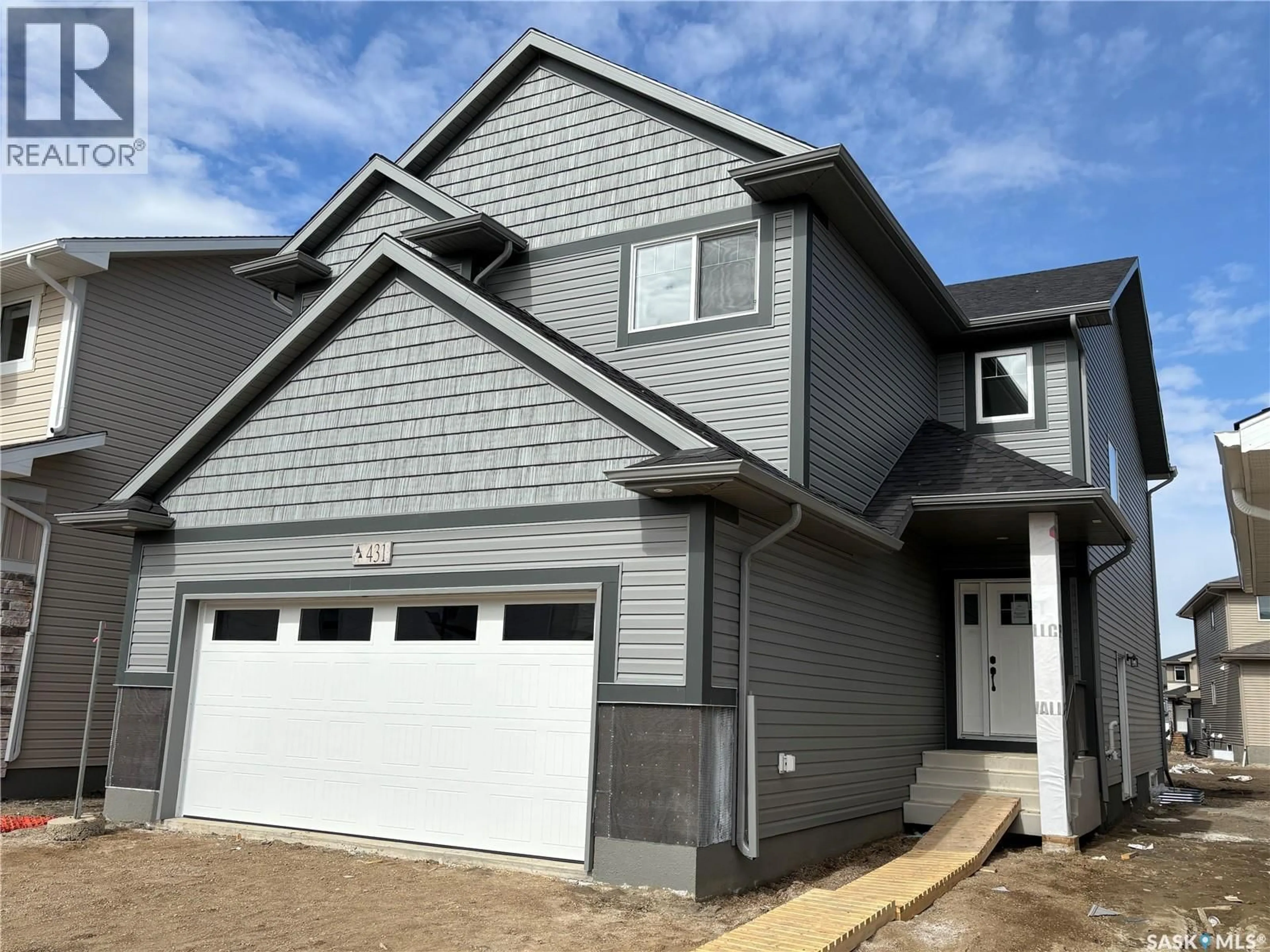 Home with vinyl exterior material, street for 539 TRAEGER MANOR, Saskatoon Saskatchewan S7V1Z8