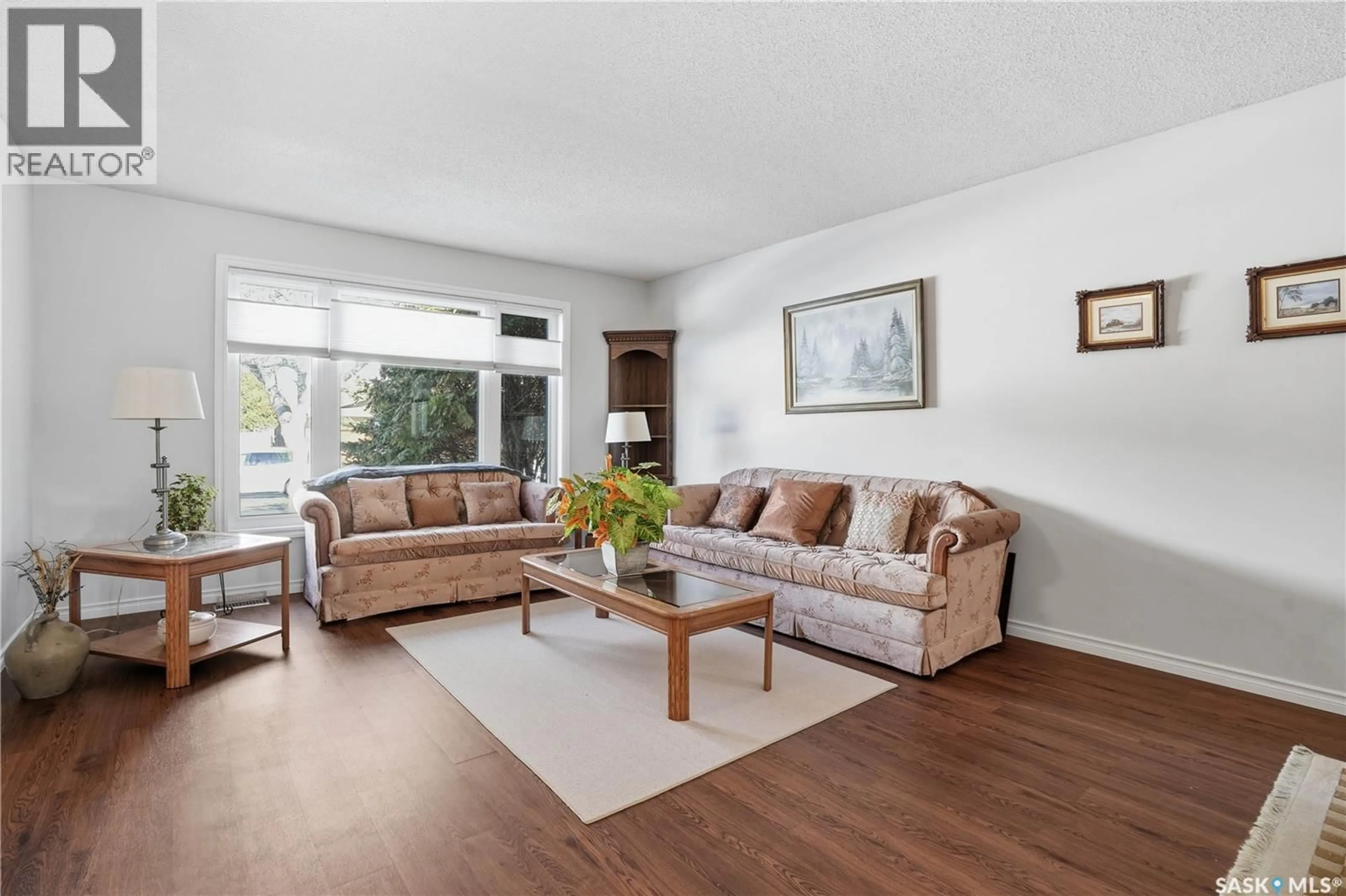 Living room with furniture, wood/laminate floor for 3338 WESTMINSTER ROAD, Regina Saskatchewan S4V0S4