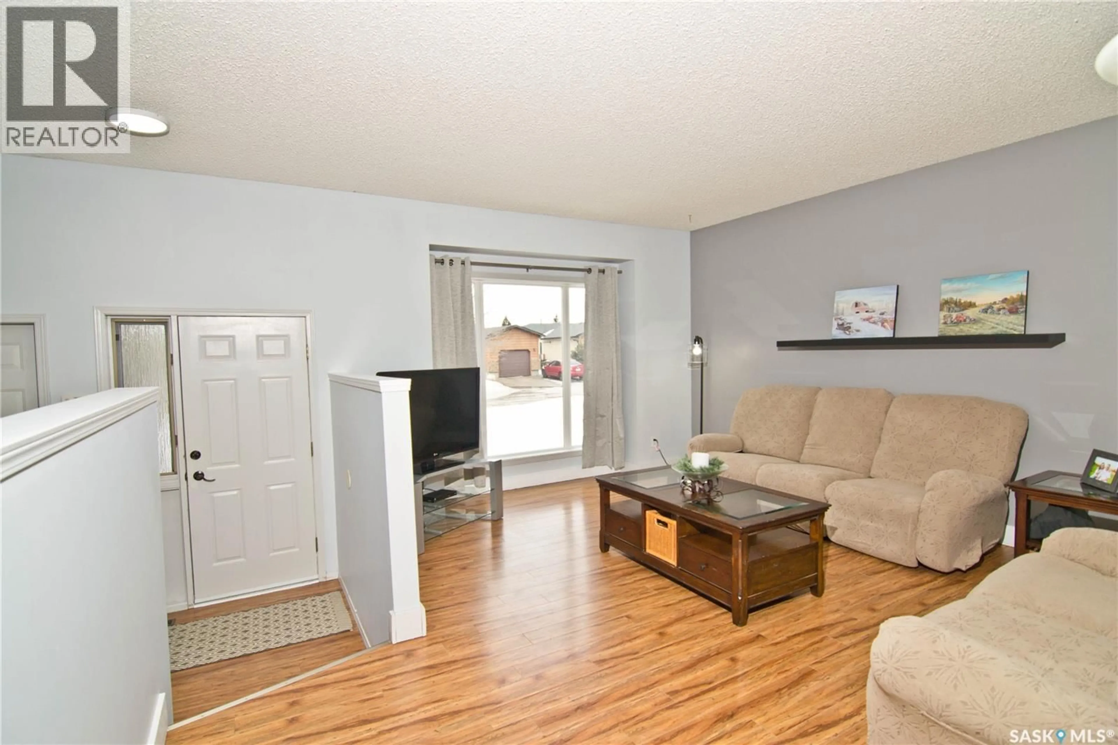 Living room with furniture, wood/laminate floor for 1026 BAYDA CRESCENT, Regina Saskatchewan S4S6Y5