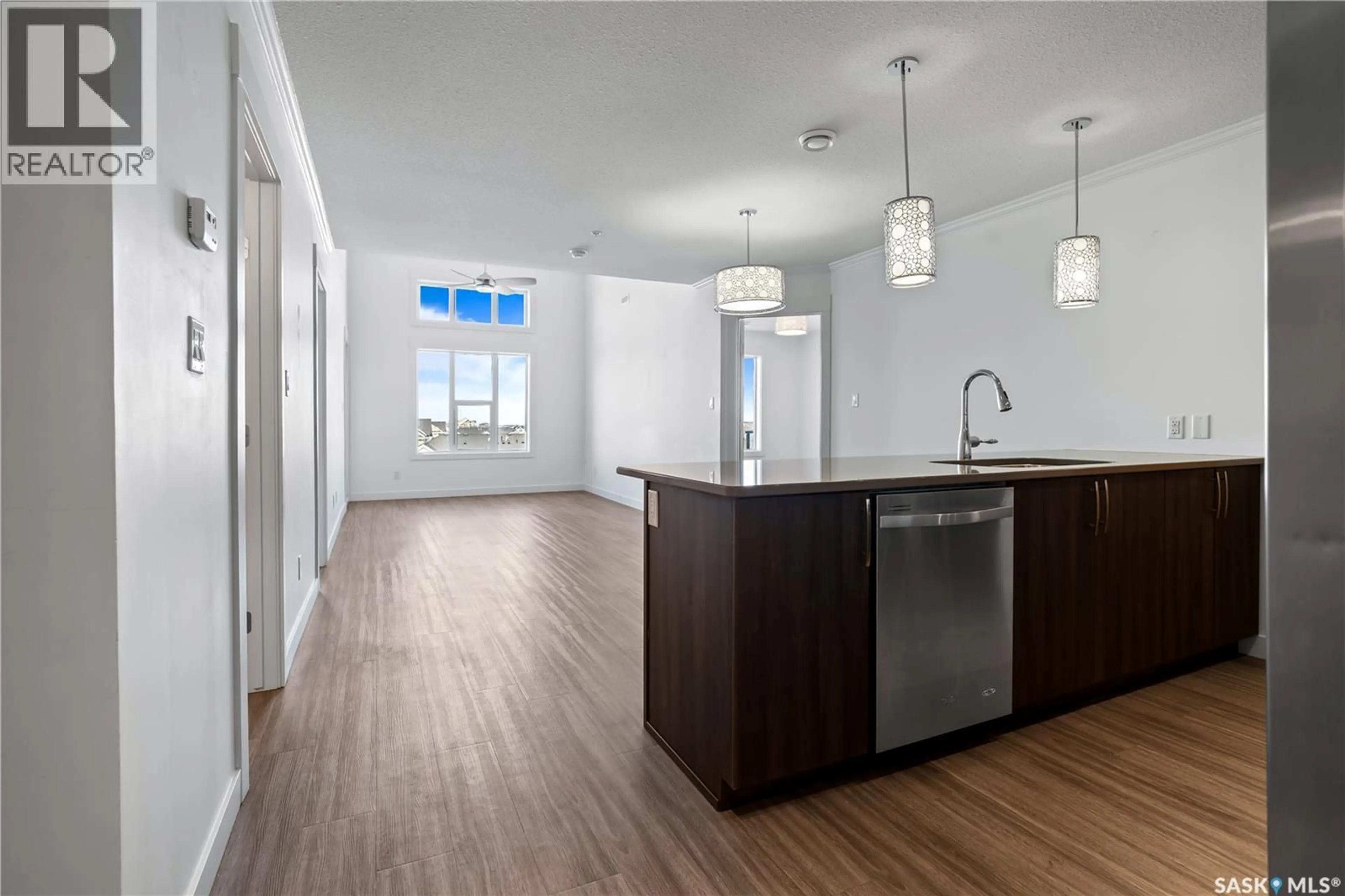 Open concept kitchen, wood/laminate floor for 5301 - 416 UNIVERSAL CRESCENT, Regina Saskatchewan S4W0L2
