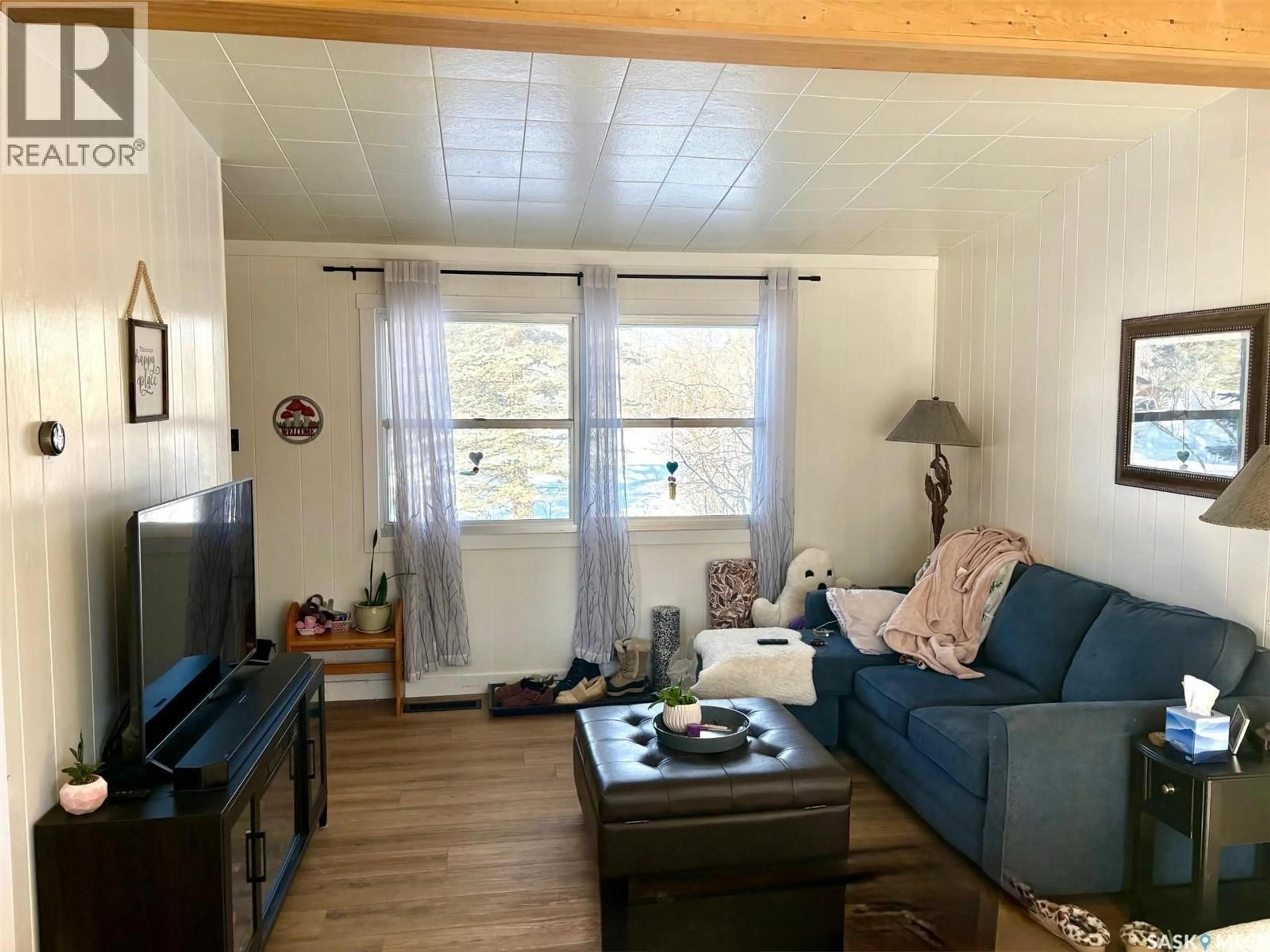 Living room with furniture, wood/laminate floor for 118 MEADOWBROOK ROAD, Good Lake Rm No. 274 Saskatchewan S0A1L0