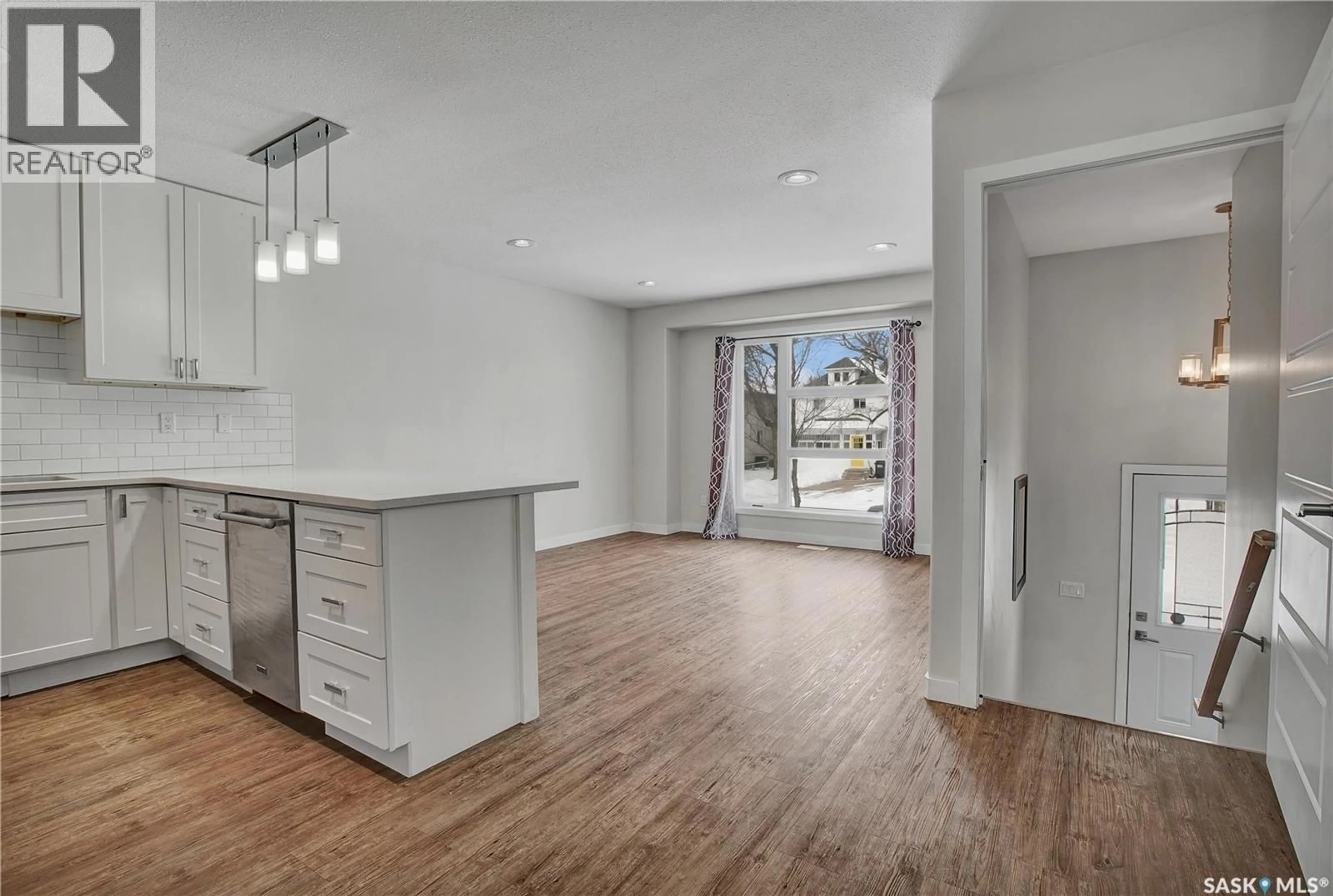 Open concept kitchen, wood/laminate floor for 305B 109TH STREET, Saskatoon Saskatchewan S7N1R6