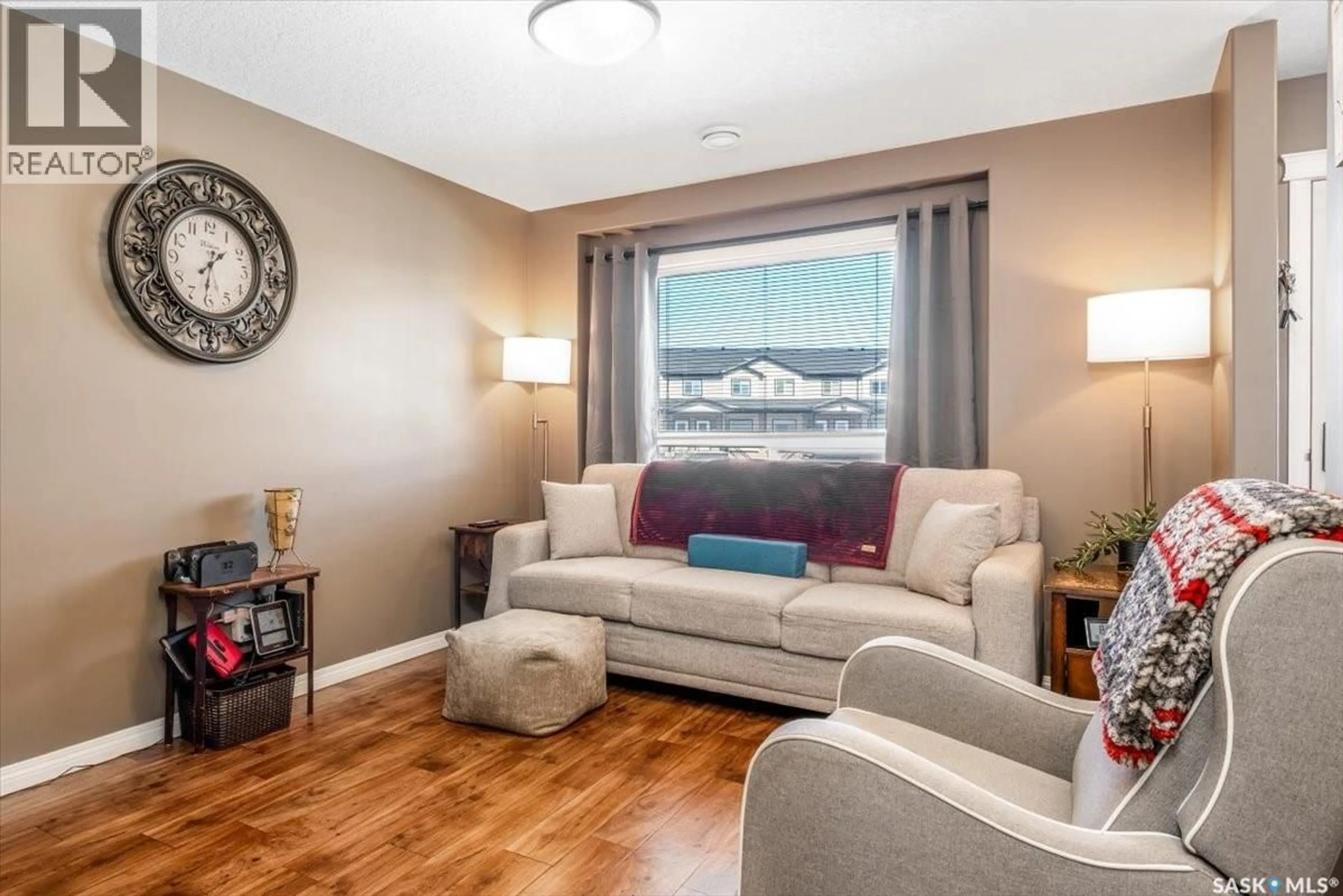 Living room with furniture, wood/laminate floor for 3806 - 715 DEWDNEY AVENUE, Regina Saskatchewan S4Z0A6