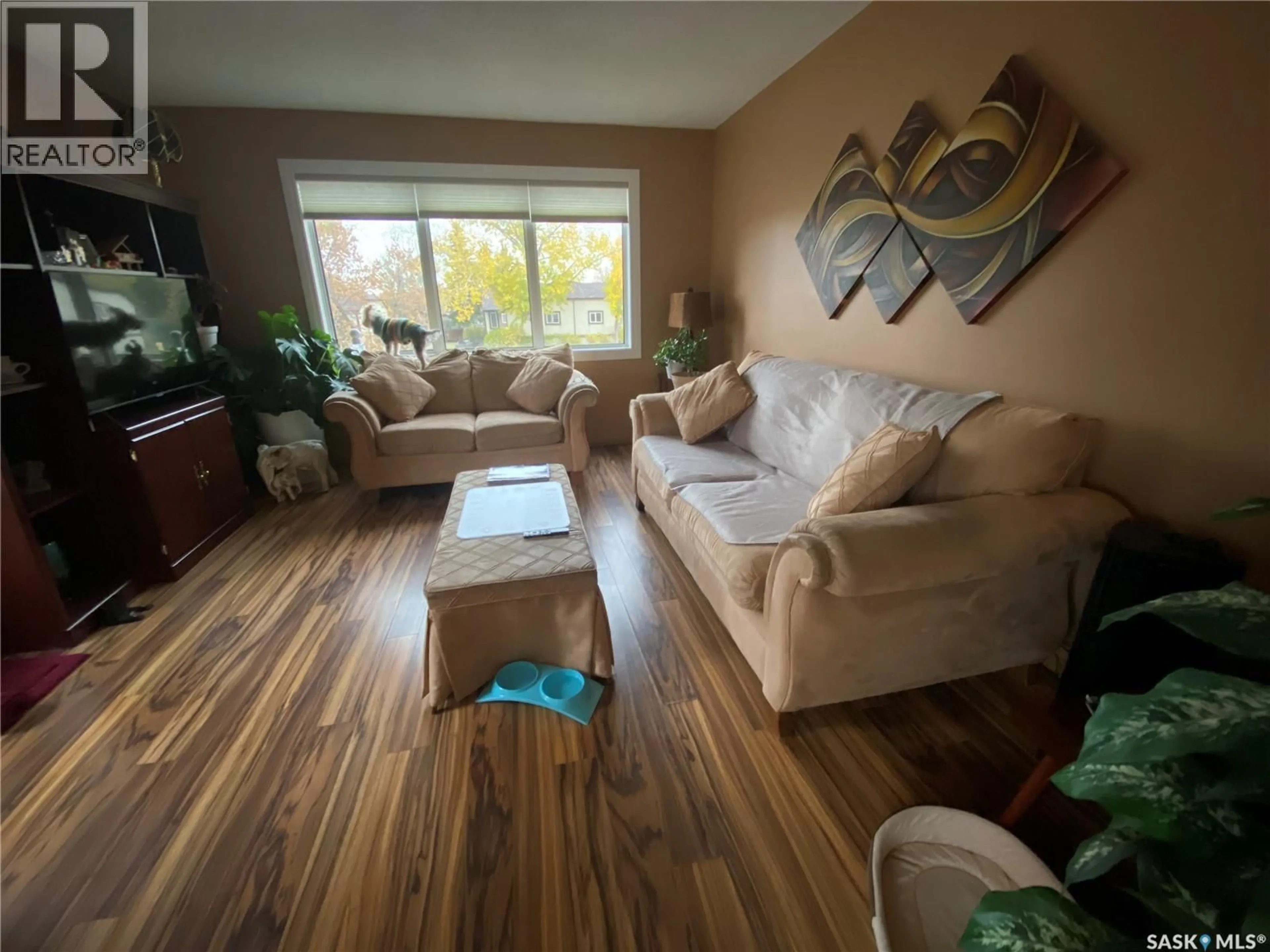 Living room with furniture, wood/laminate floor for 6946 BLAKENEY DRIVE, Regina Saskatchewan S4X2N5