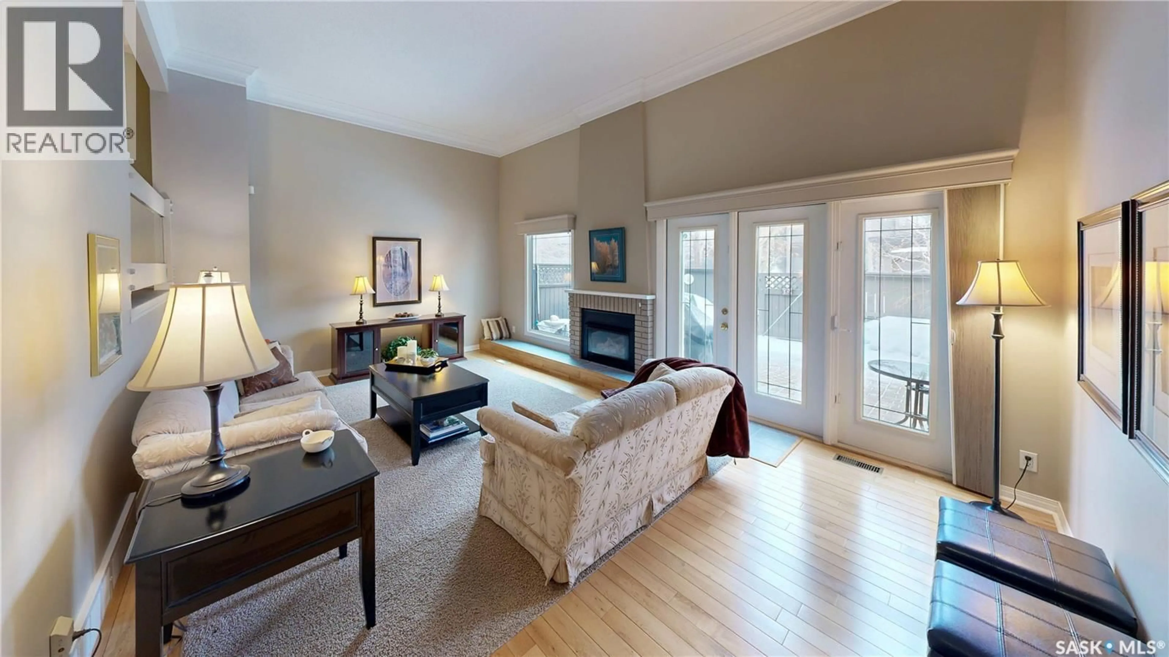 Living room with furniture, wood/laminate floor for 110 QUINCY DRIVE, Regina Saskatchewan S4S6M1