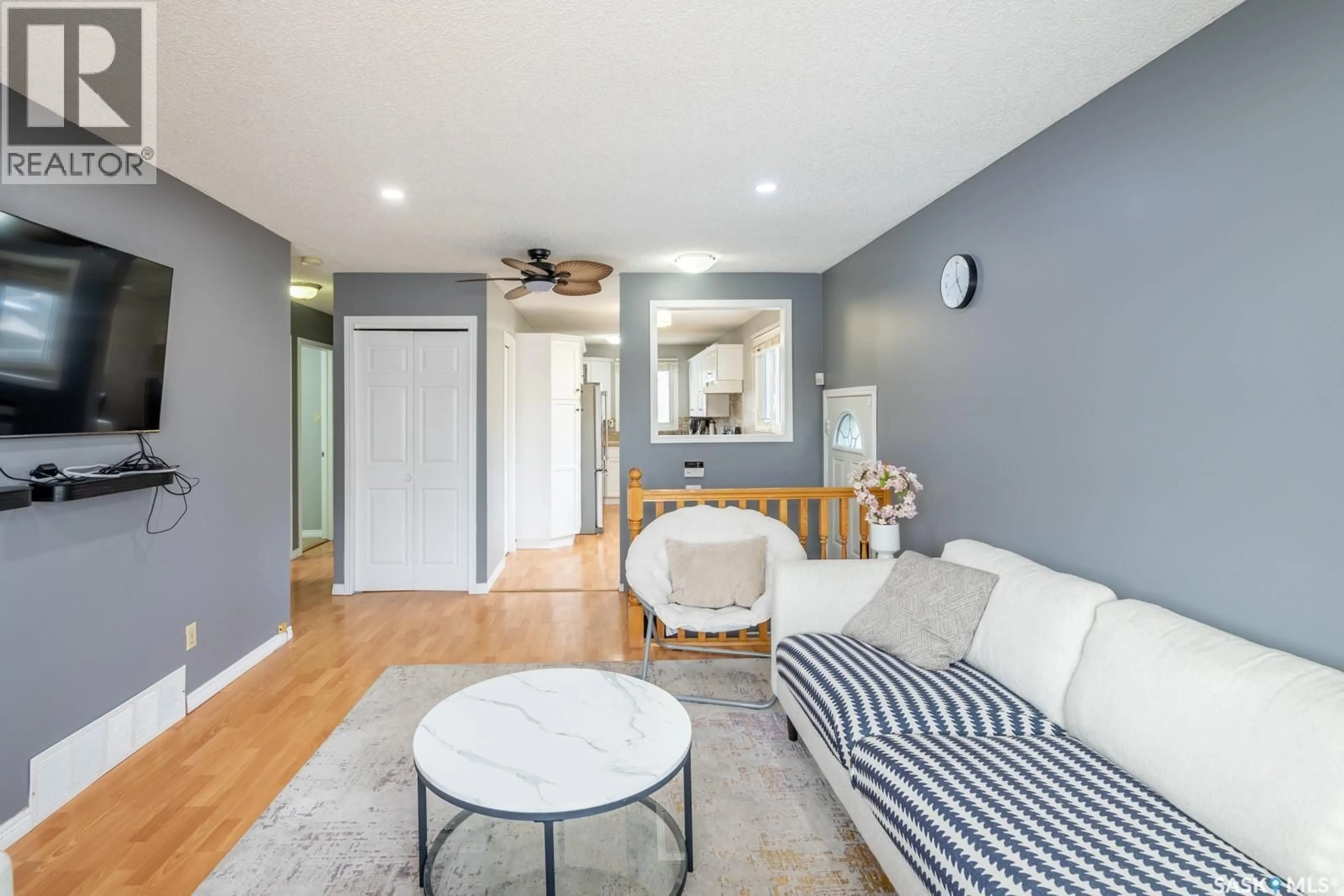 Living room with furniture, wood/laminate floor for 174 THOMSON AVENUE, Regina Saskatchewan S4N5L3