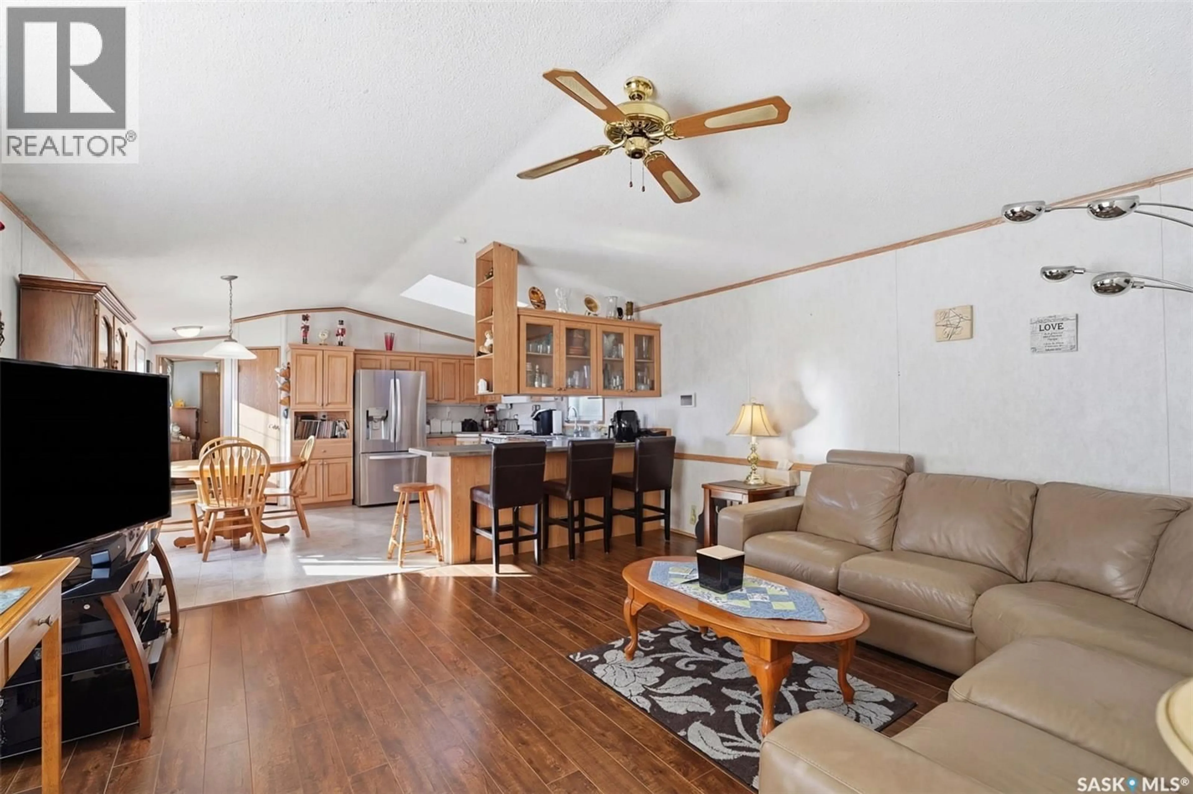 Living room with furniture, wood/laminate floor for 200 CYPRESS WAY, Blucher Rm No. 343 Saskatchewan S7B0A4