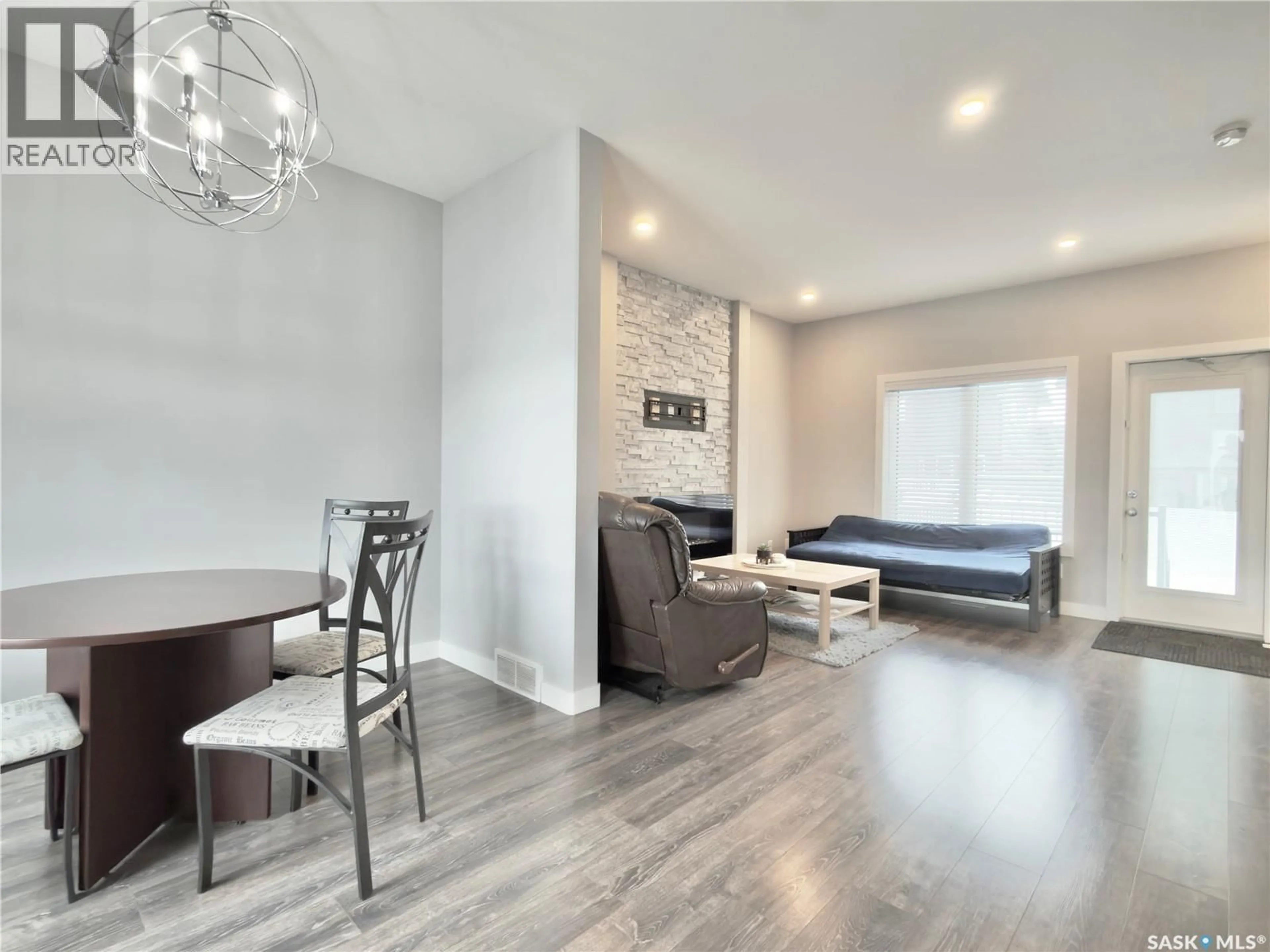 Living room with furniture, wood/laminate floor for 254 - 22 BRIGHTON GATE, Saskatoon Saskatchewan S7V0R1