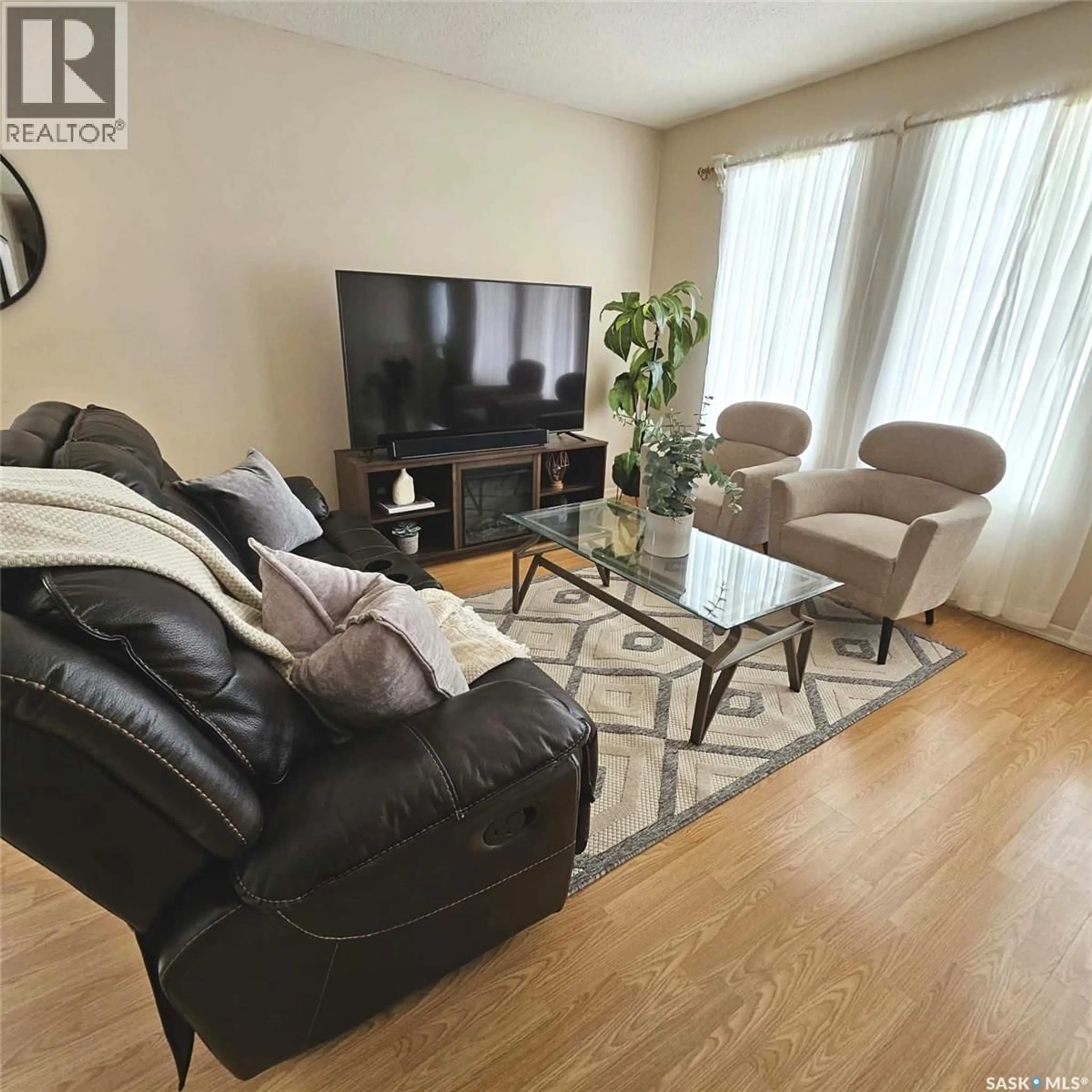 Living room with furniture, wood/laminate floor for 6114 1ST AVENUE, Regina Saskatchewan S4T6Z7
