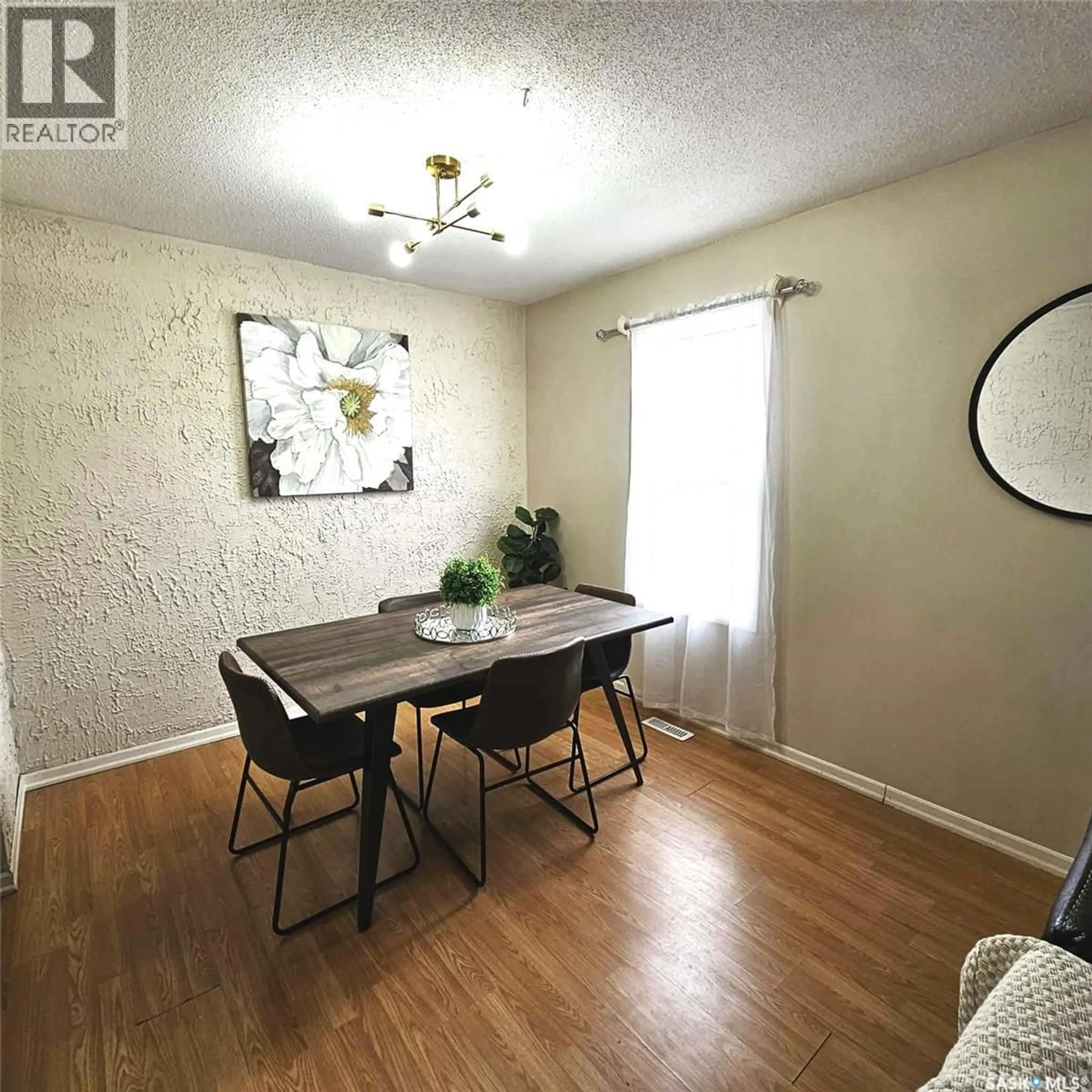 Dining room, wood/laminate floor for 6114 1ST AVENUE, Regina Saskatchewan S4T6Z7