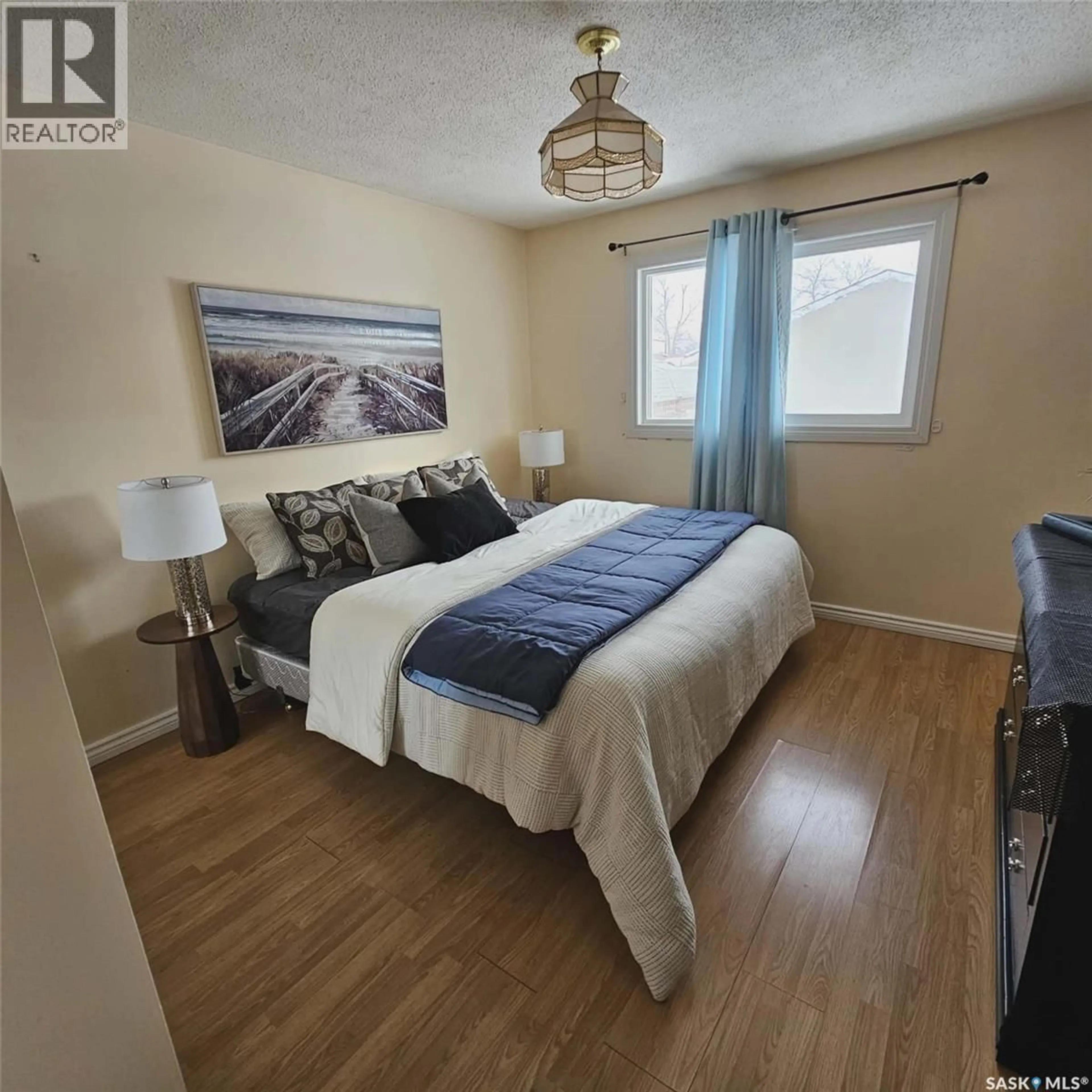 Bedroom with bed, wood/laminate floor for 6114 1ST AVENUE, Regina Saskatchewan S4T6Z7