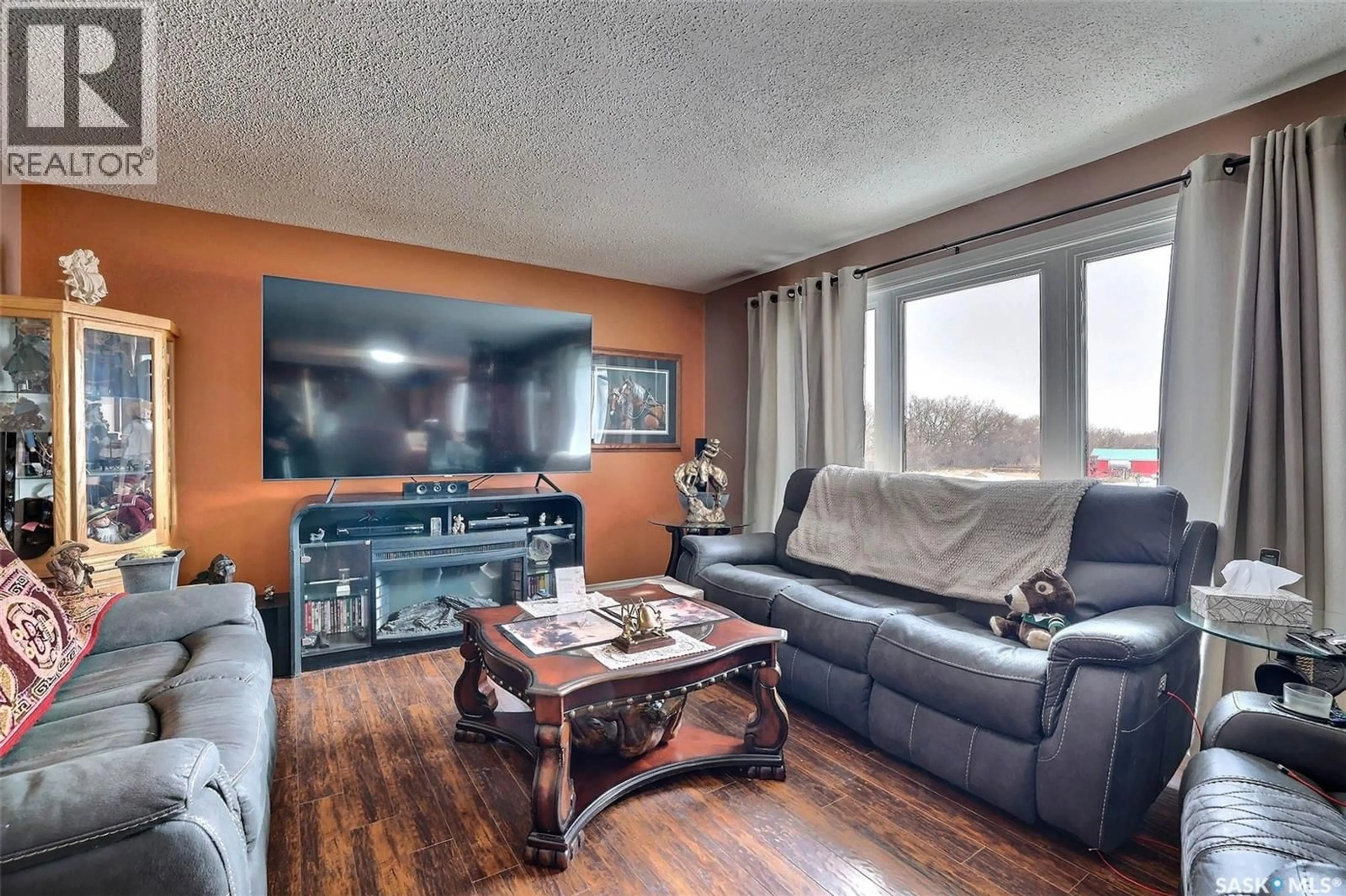 Living room with furniture, wood/laminate floor for HOWELL ACREAGE, Lumsden Rm No. 189 Saskatchewan S0G3C0