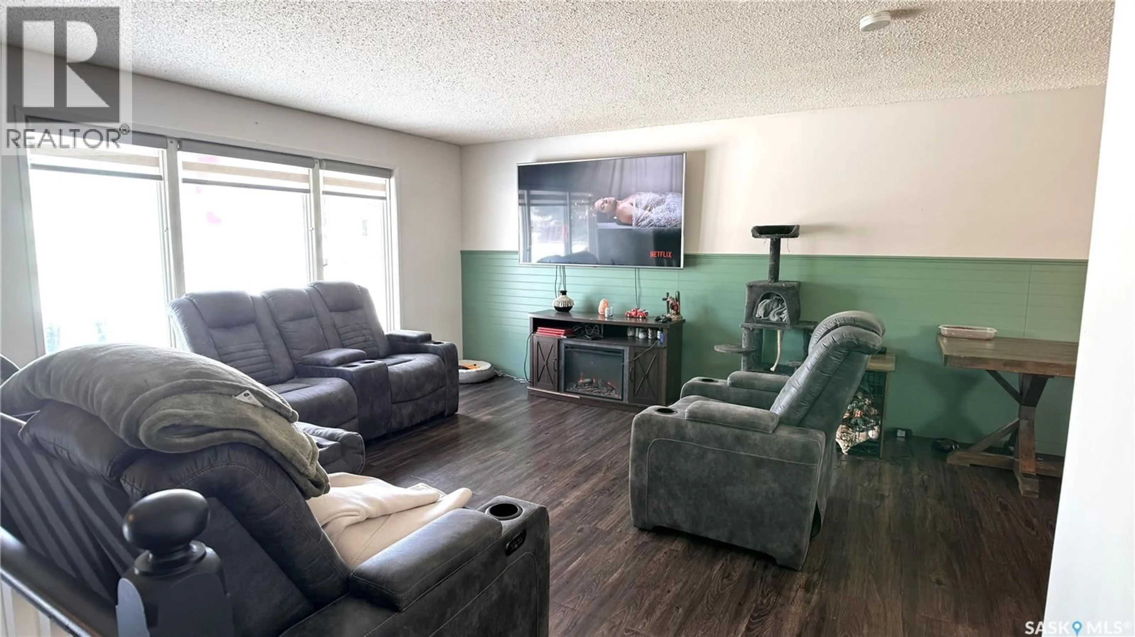 Living room with furniture, wood/laminate floor for 422 SPRUCE DRIVE, Estevan Saskatchewan S4A2A8