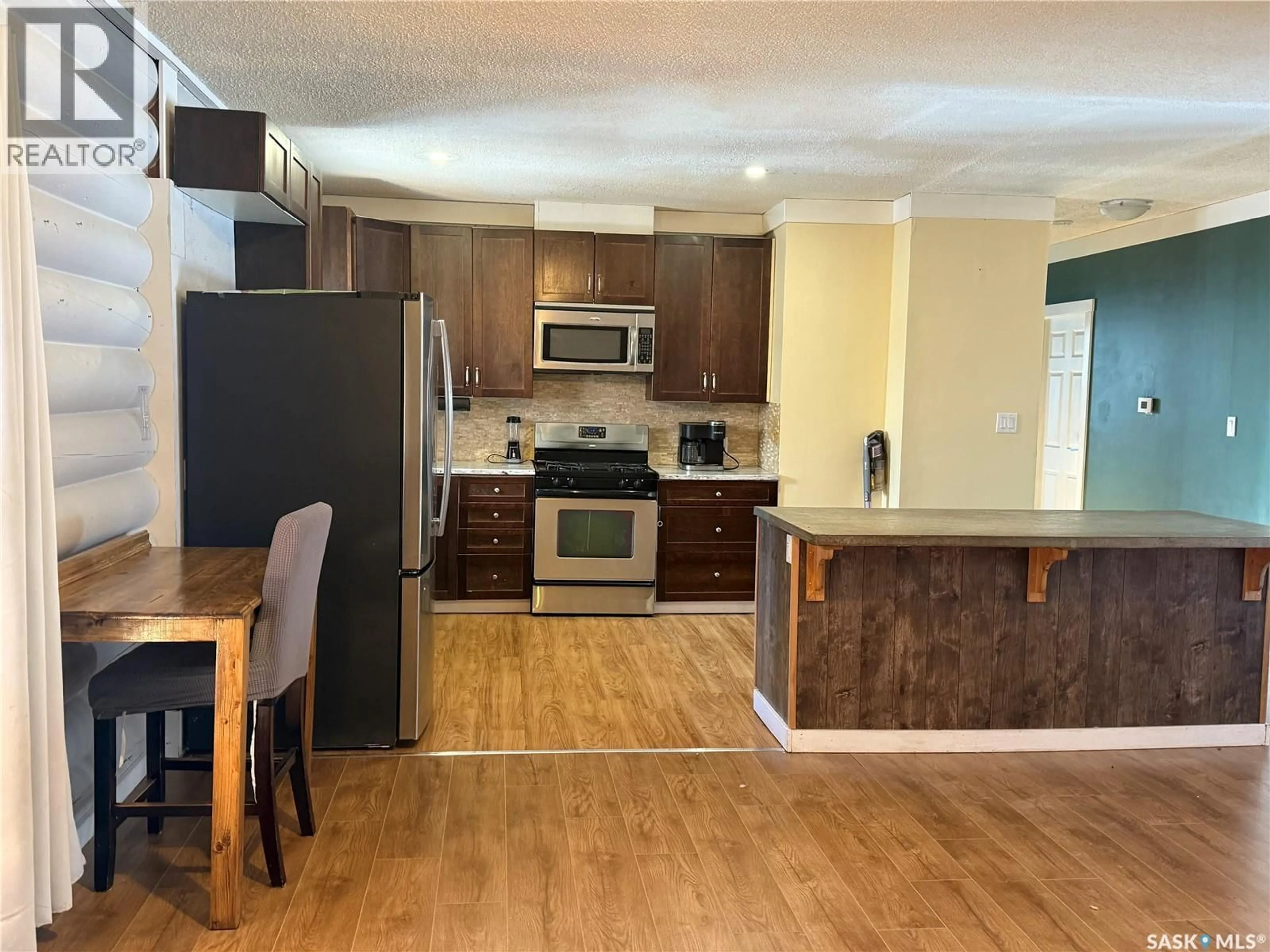 Open concept kitchen, wood/laminate floor for 804 STUDER STREET, La Ronge Saskatchewan S0J1L0