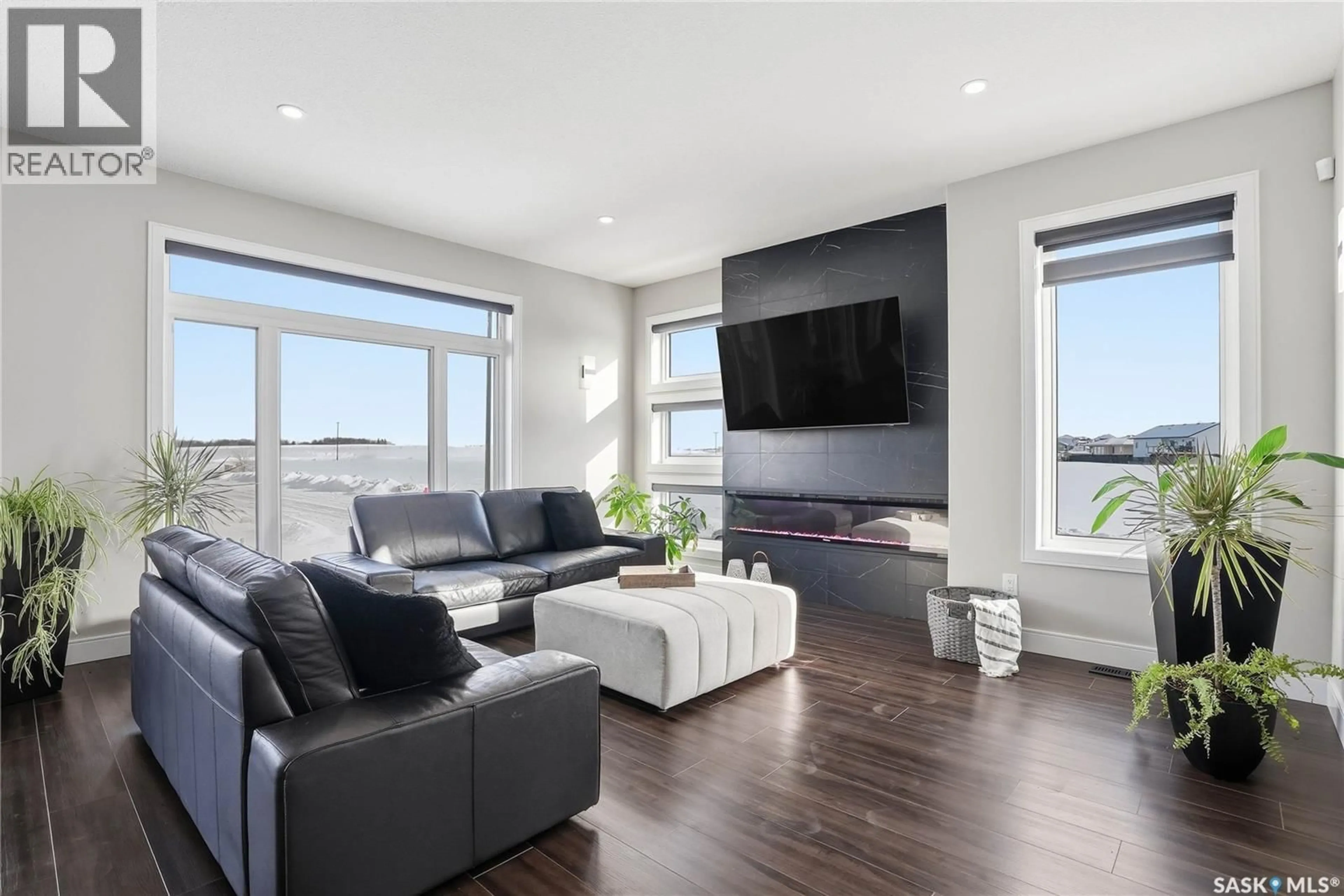 Living room with furniture, wood/laminate floor for 24 WILSON BAY, Prince Albert Saskatchewan S6X0A6