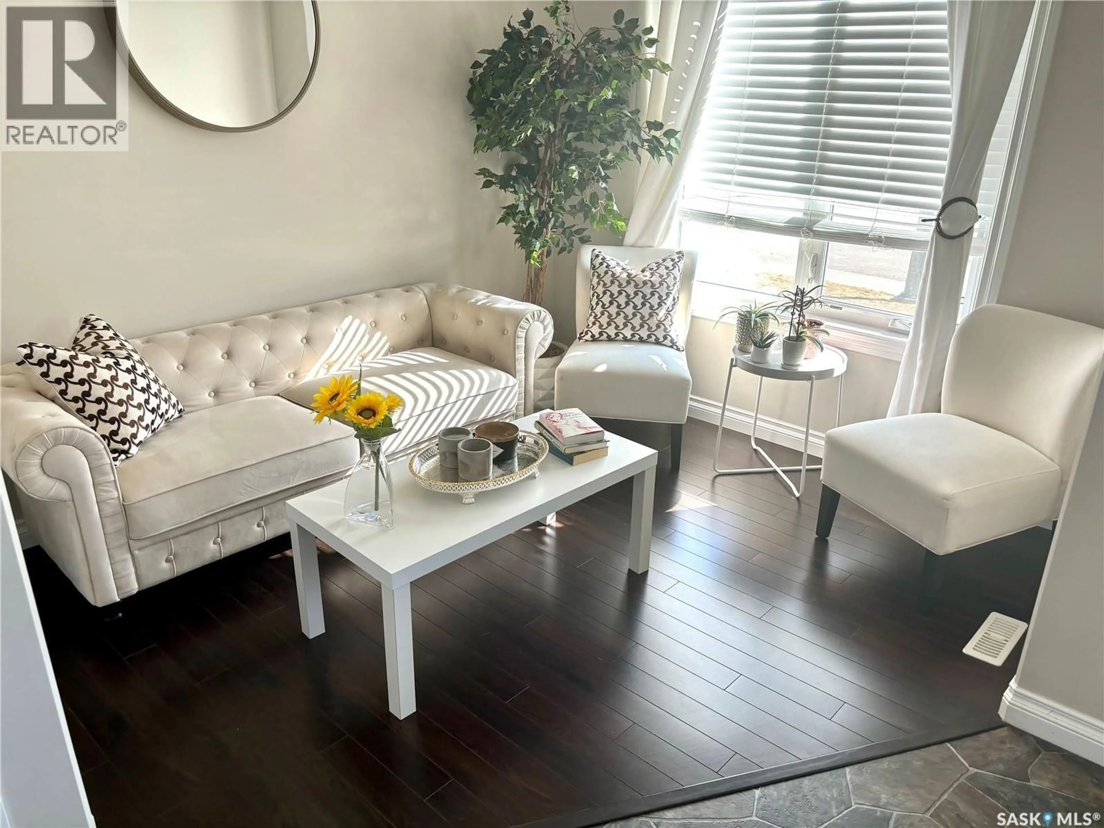 Living room with furniture, wood/laminate floor for 104 ATTON CRESCENT, Saskatoon Saskatchewan S7W0N9