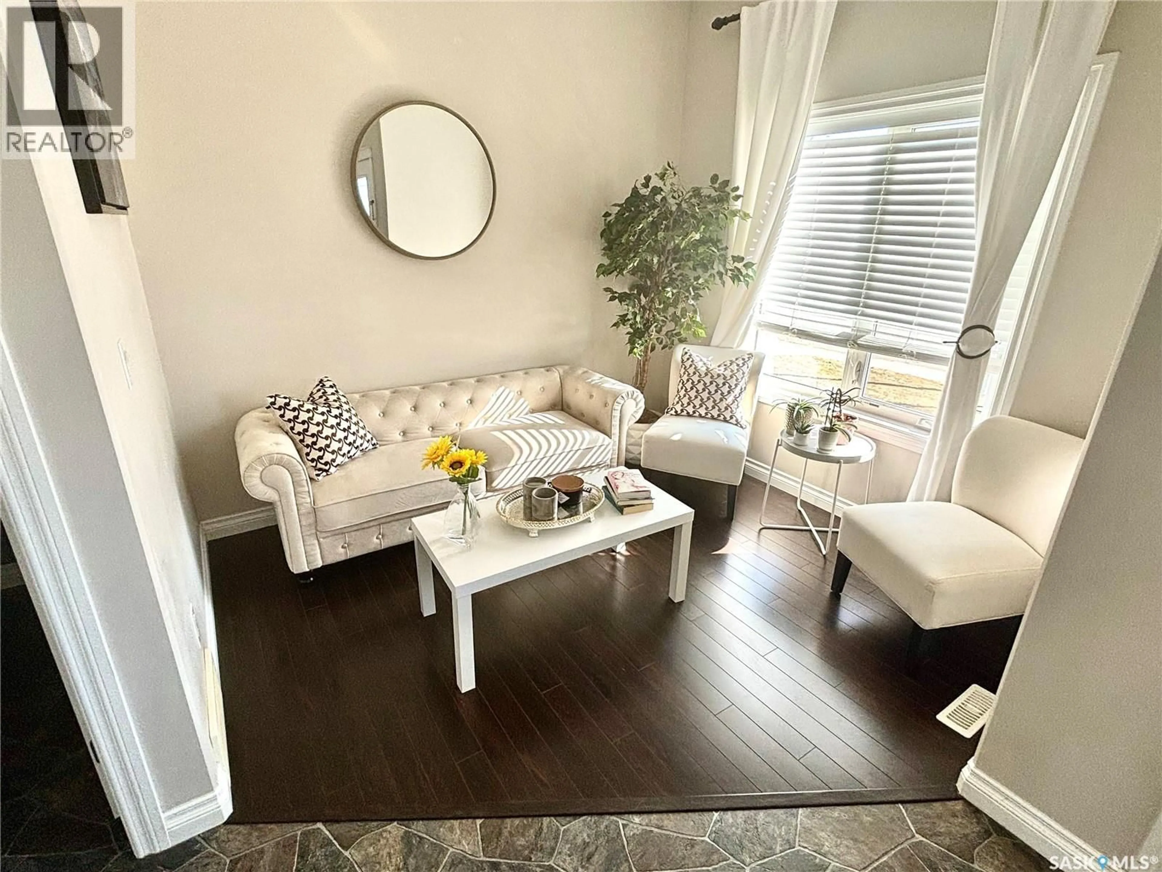 Living room with furniture, wood/laminate floor for 104 ATTON CRESCENT, Saskatoon Saskatchewan S7W0N9