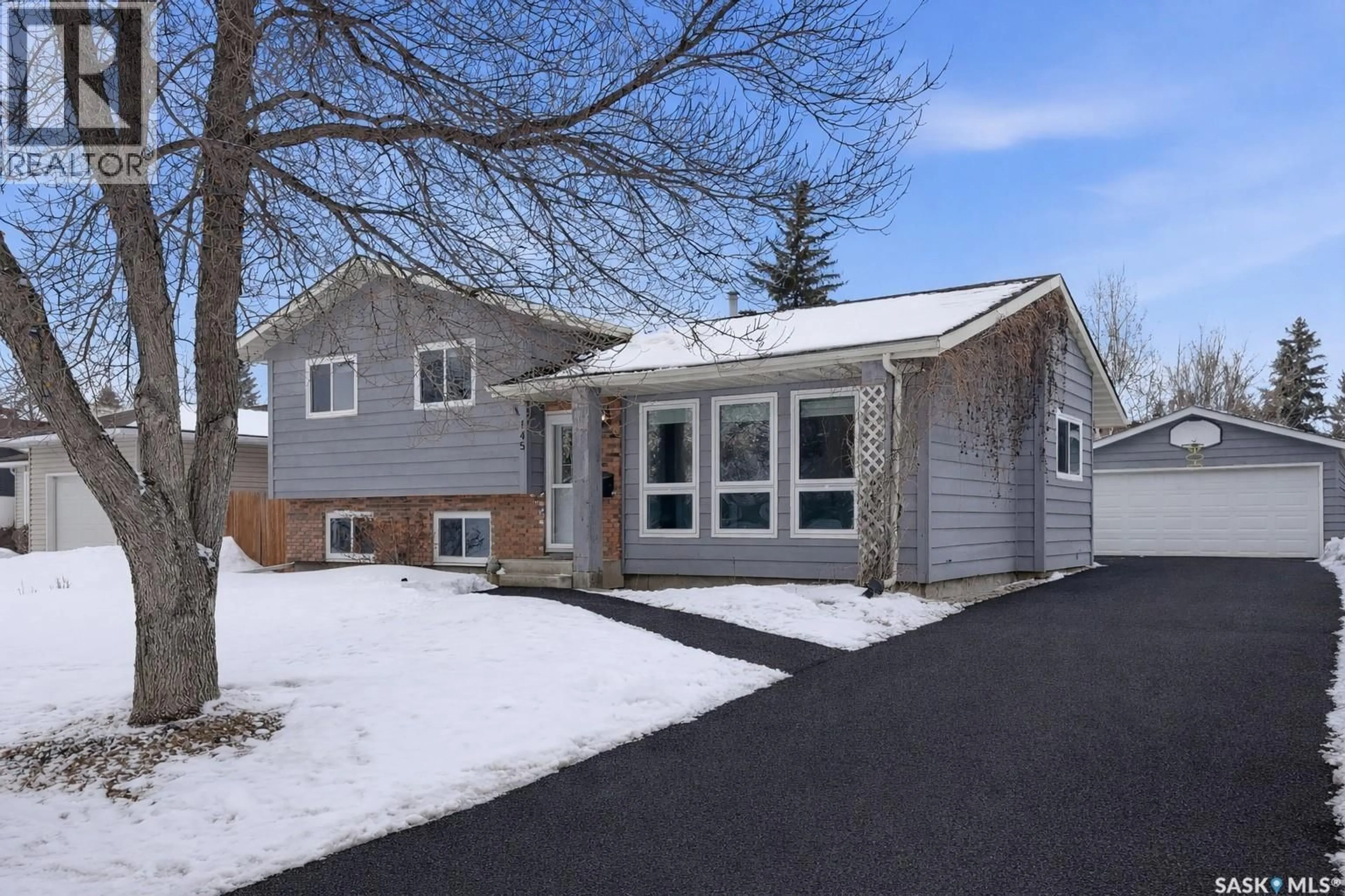 Home with vinyl exterior material, street for 145 STILLWATER DRIVE, Saskatoon Saskatchewan S7J3N9