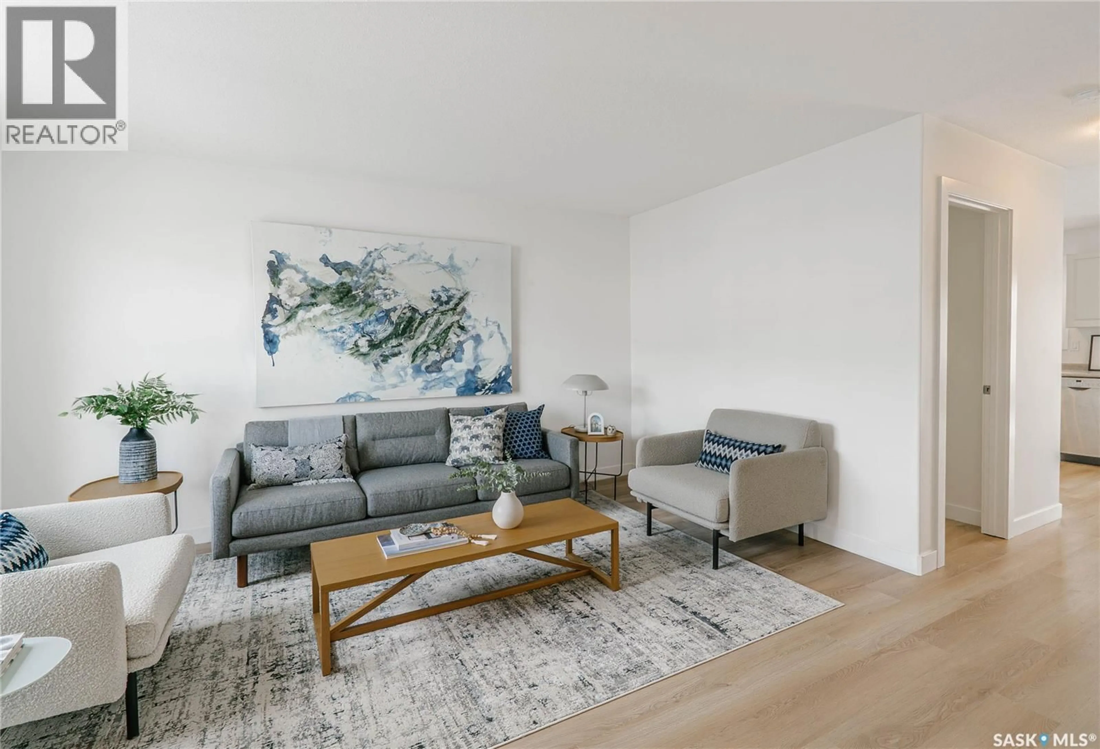 Living room with furniture, wood/laminate floor for 203 - 135 HEROLD TERRACE, Saskatoon Saskatchewan S7V1H7