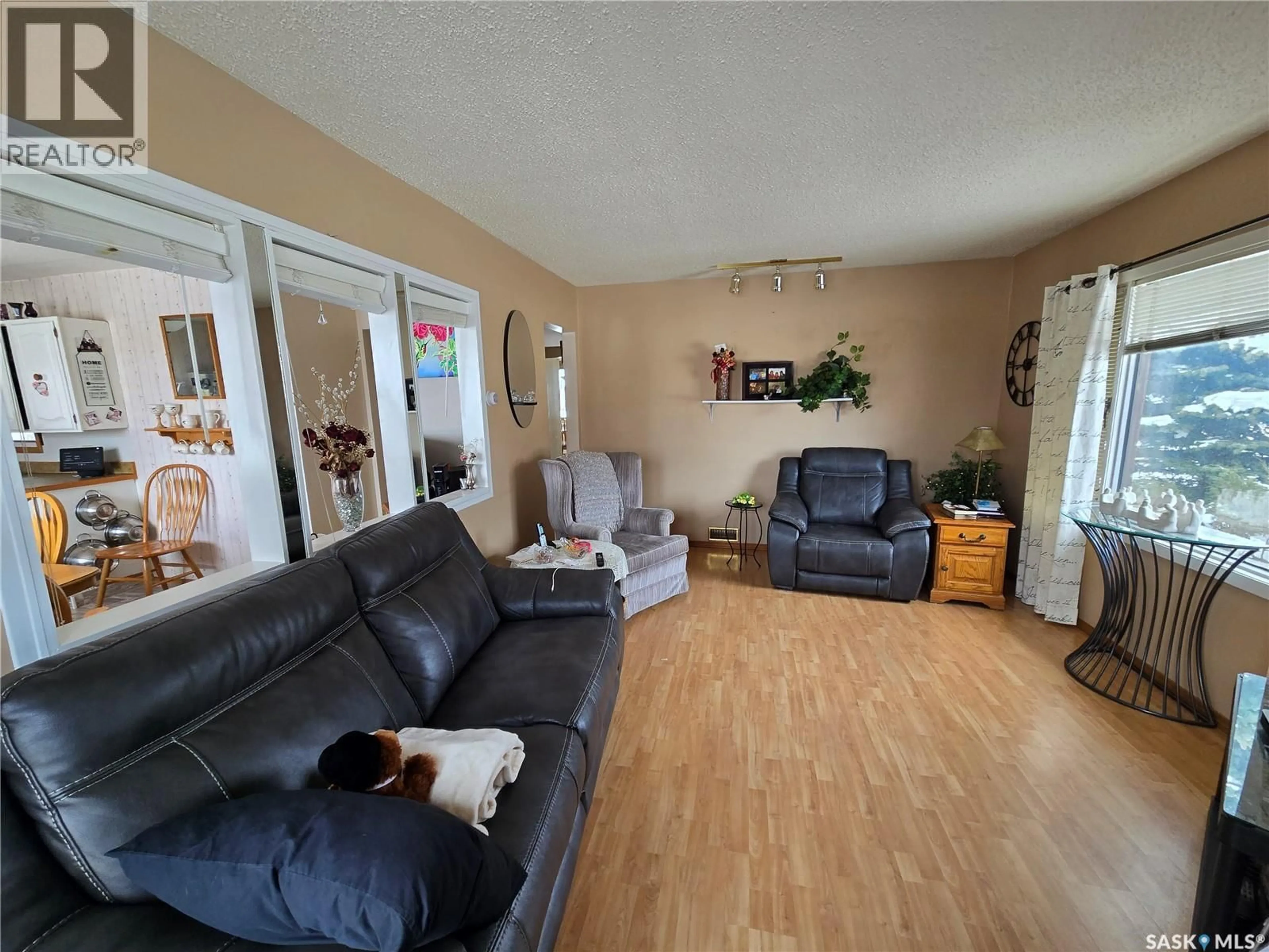 Living room with furniture, wood/laminate floor for 676 3RD AVENUE, Swift Current Saskatchewan S9H2H5
