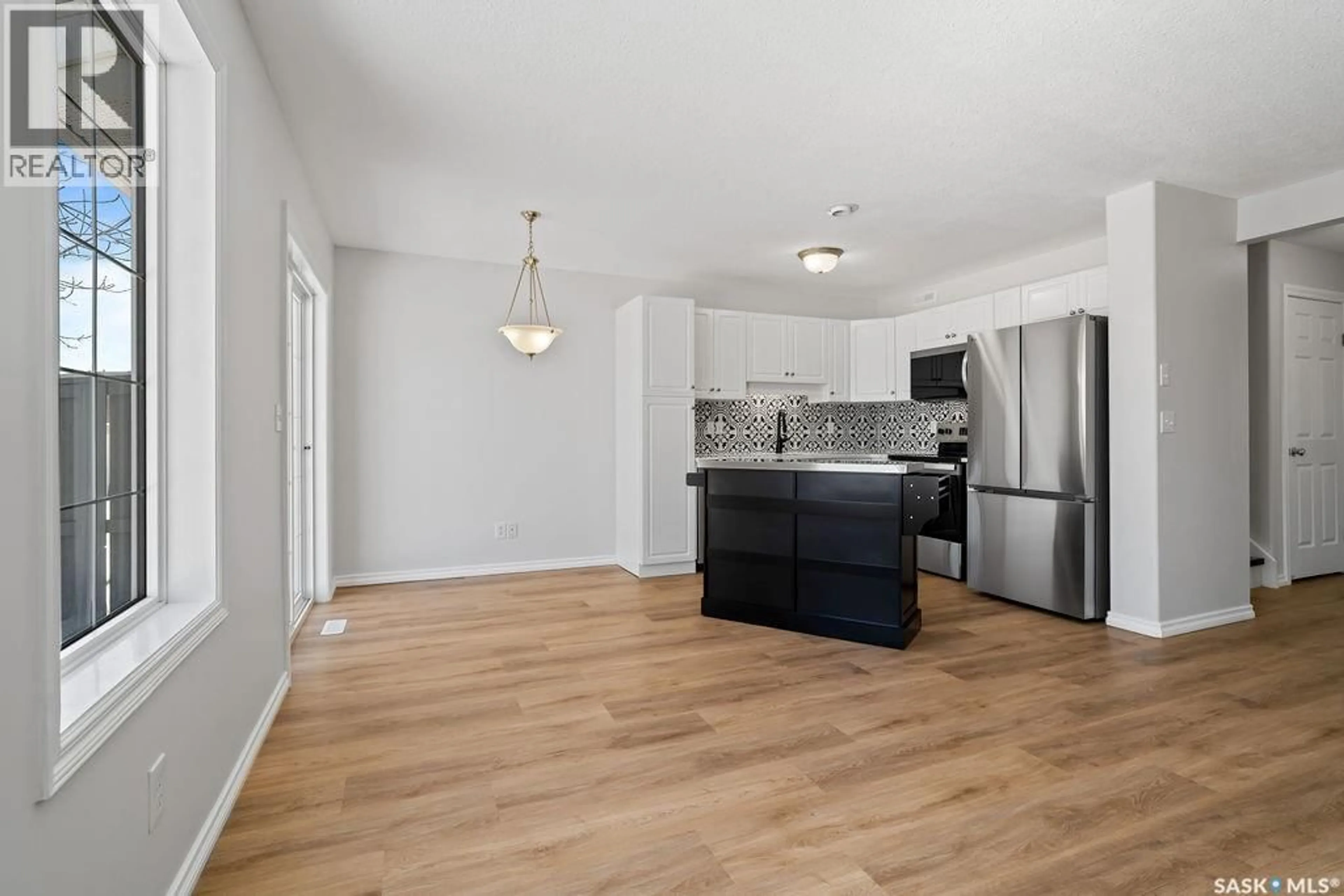Open concept kitchen, wood/laminate floor for 48 2400 TELL PLACE, Regina Saskatchewan S4V3E3