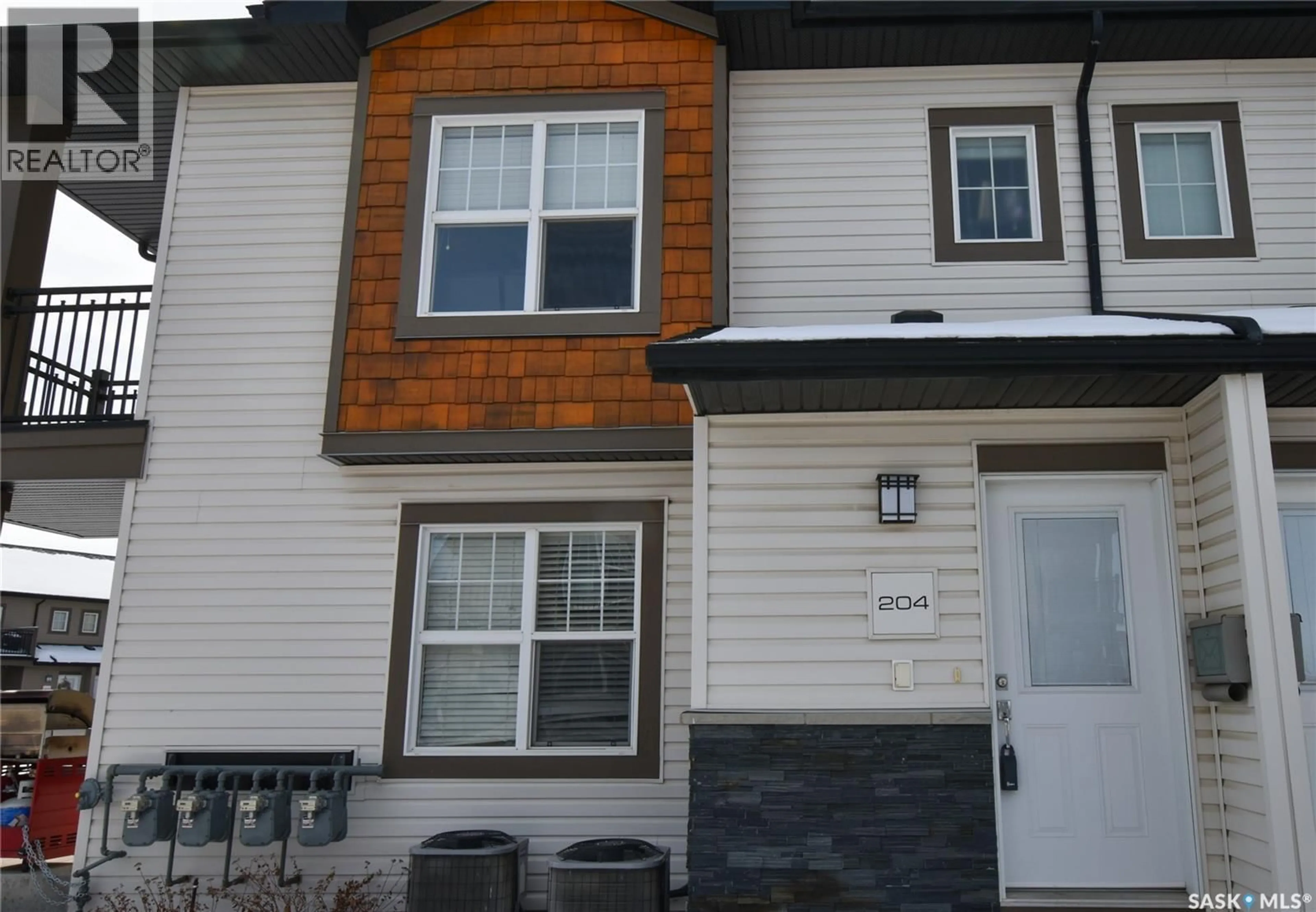 Home with vinyl exterior material, street for 204 - 2315 MCCLOCKLIN ROAD, Saskatoon Saskatchewan S7R0K7
