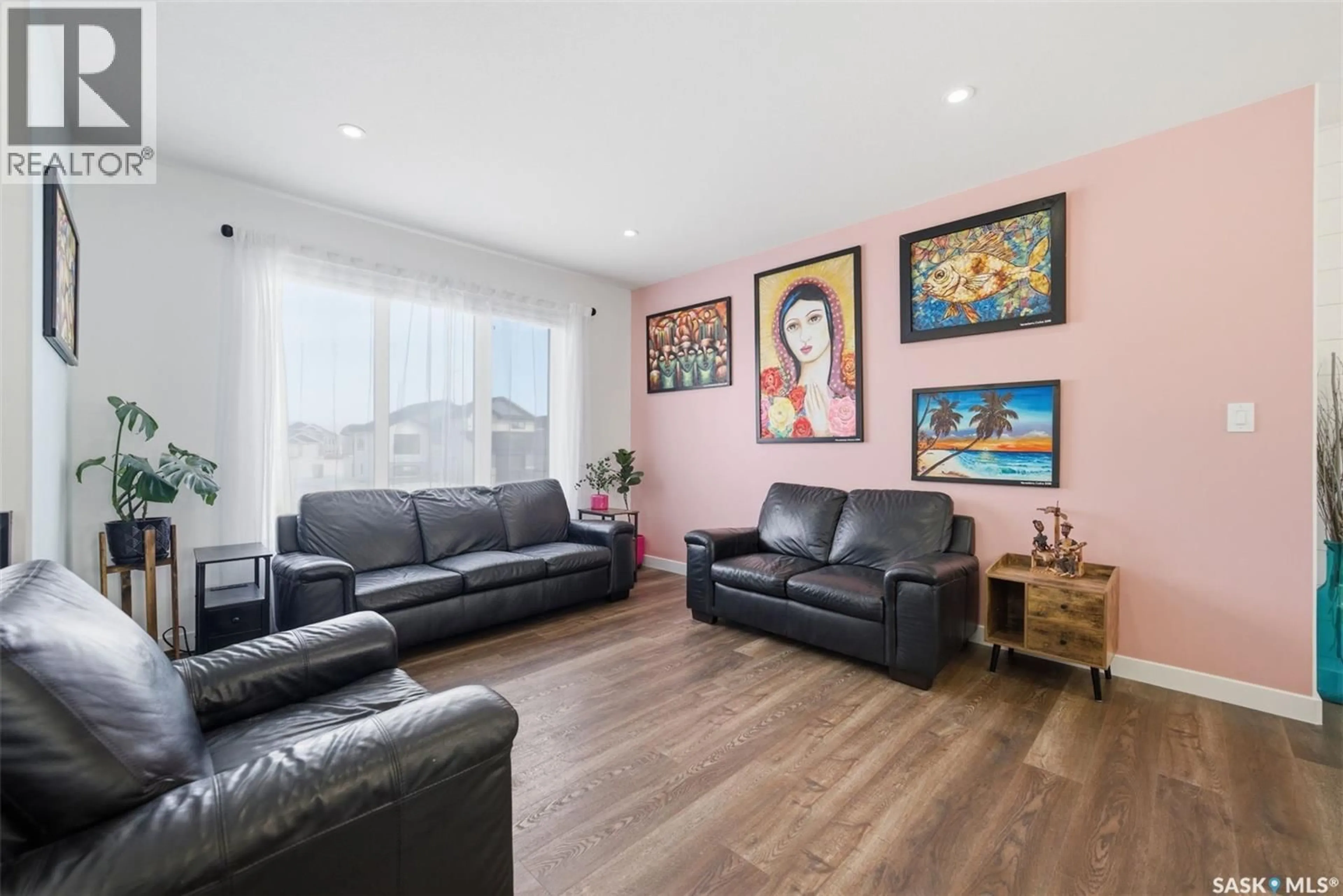 Living room with furniture, wood/laminate floor for 805 WEIR CRESCENT, Warman Saskatchewan S0K4S4