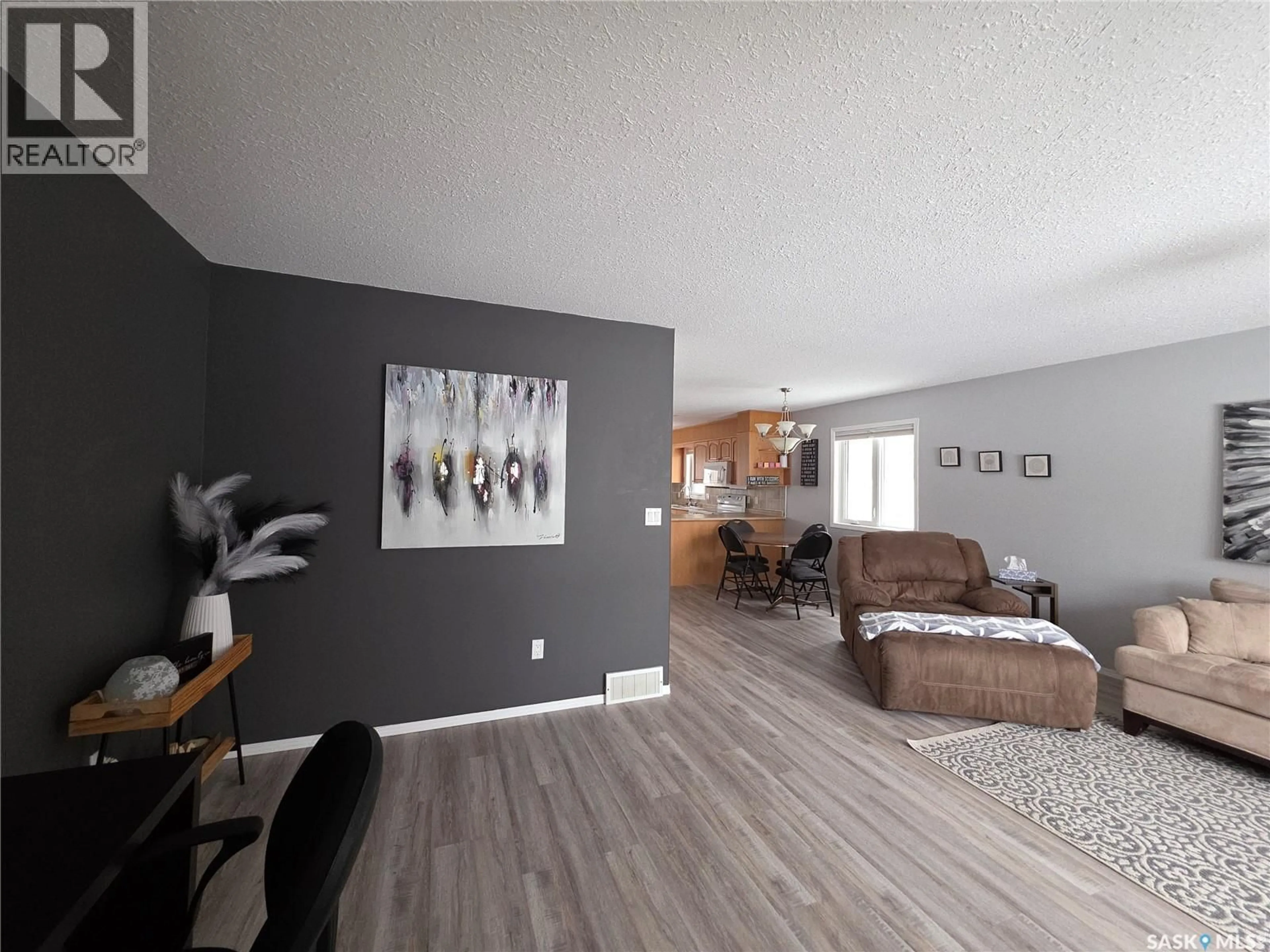Living room with furniture, wood/laminate floor for 603 MAIN STREET, Melville Saskatchewan S0A2P0