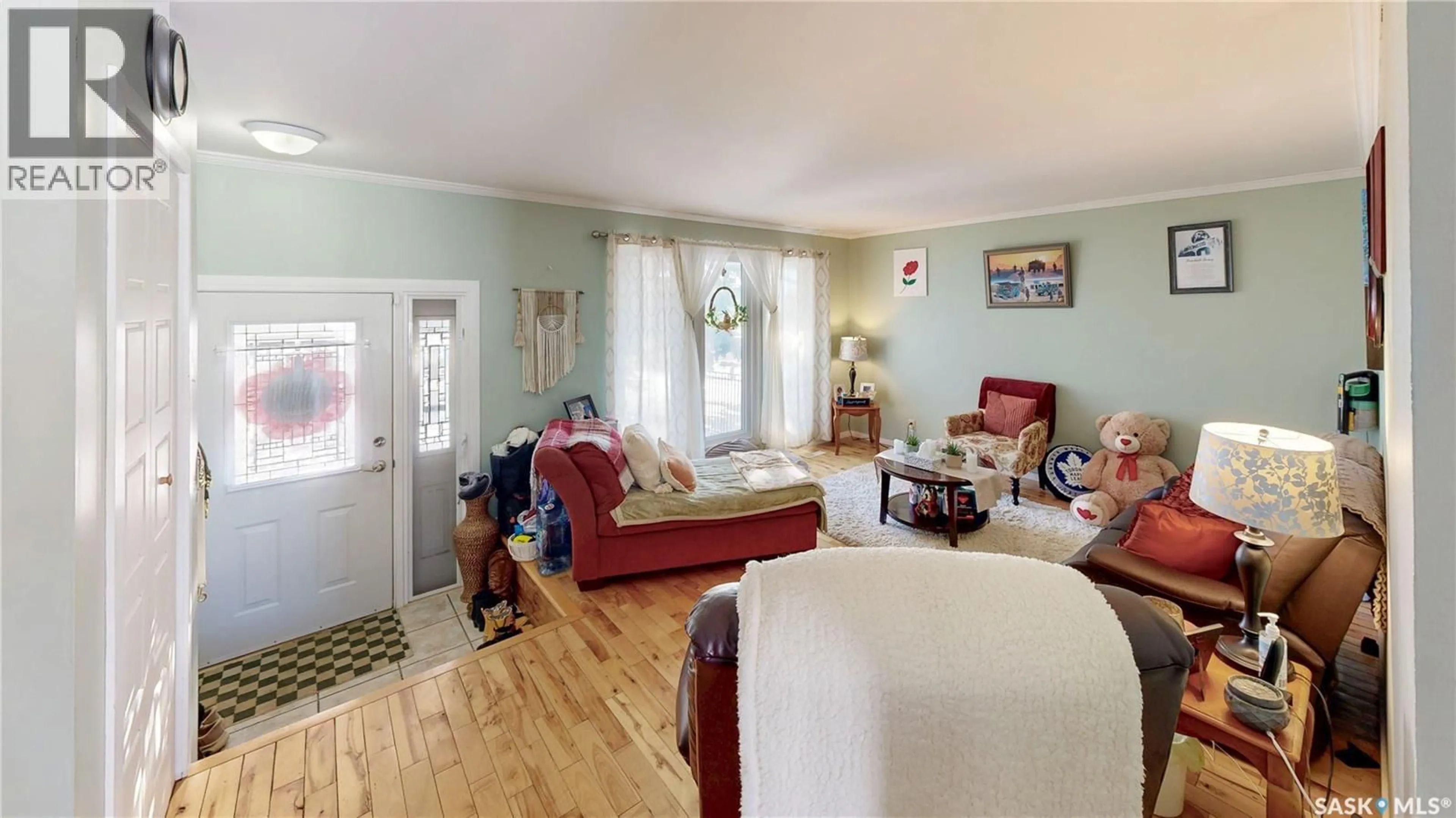 Living room with furniture, wood/laminate floor for 6150 7TH AVENUE, Regina Saskatchewan S4T7G8