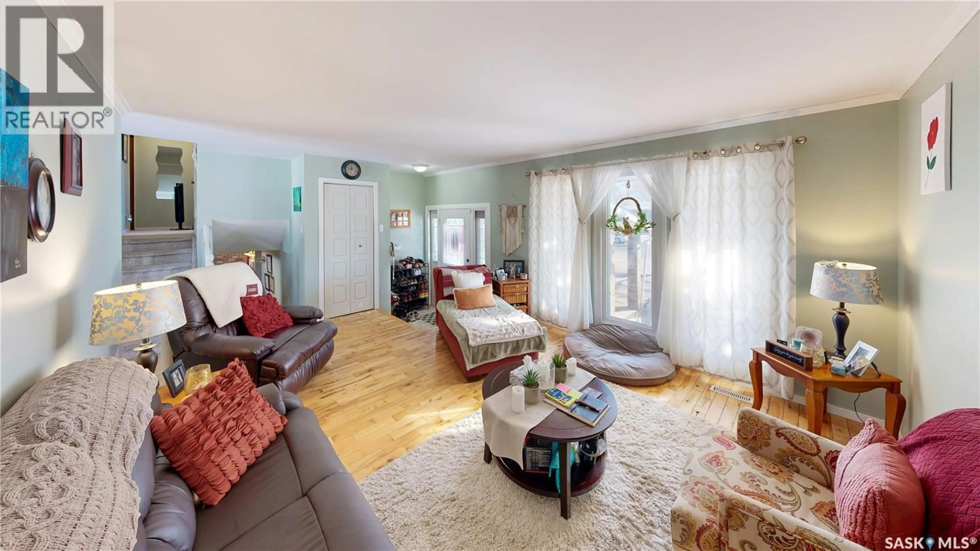 Living room with furniture, wood/laminate floor for 6150 7TH AVENUE, Regina Saskatchewan S4T7G8