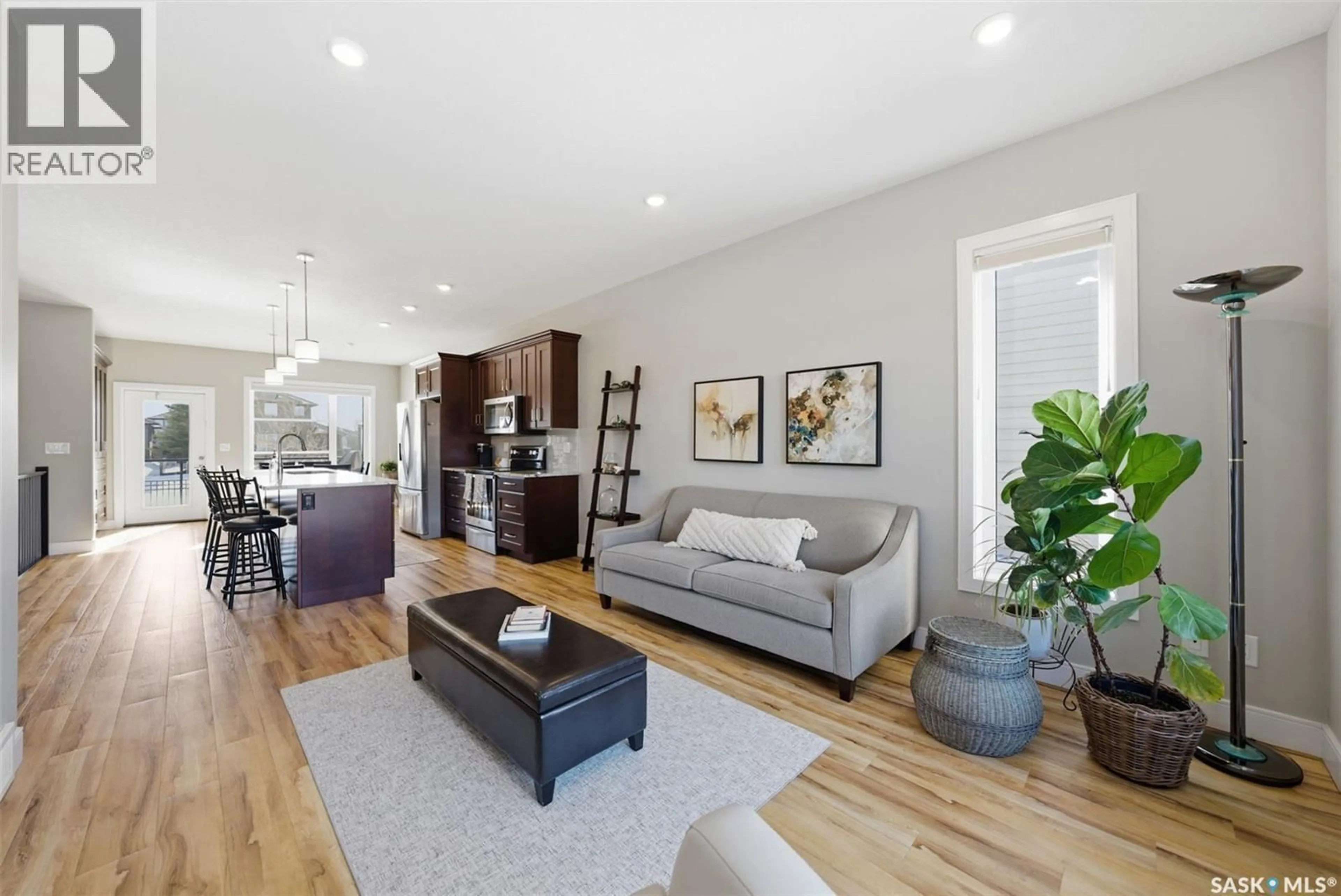 Living room with furniture, wood/laminate floor for 103 - 26 POHORECKY CRESCENT, Saskatoon Saskatchewan S7W0X6