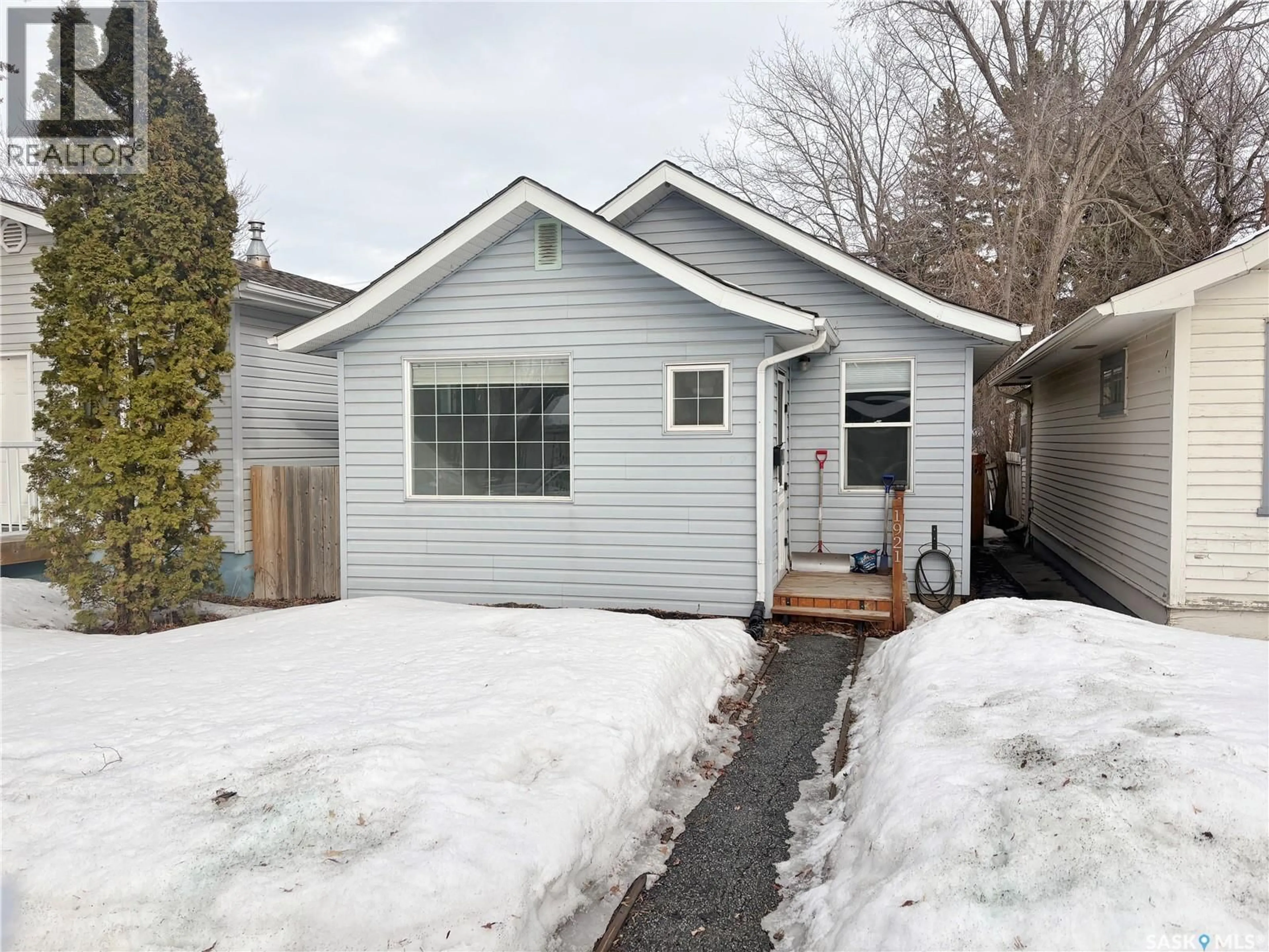Home with vinyl exterior material, street for 1921 COY AVENUE, Saskatoon Saskatchewan S7M0H9