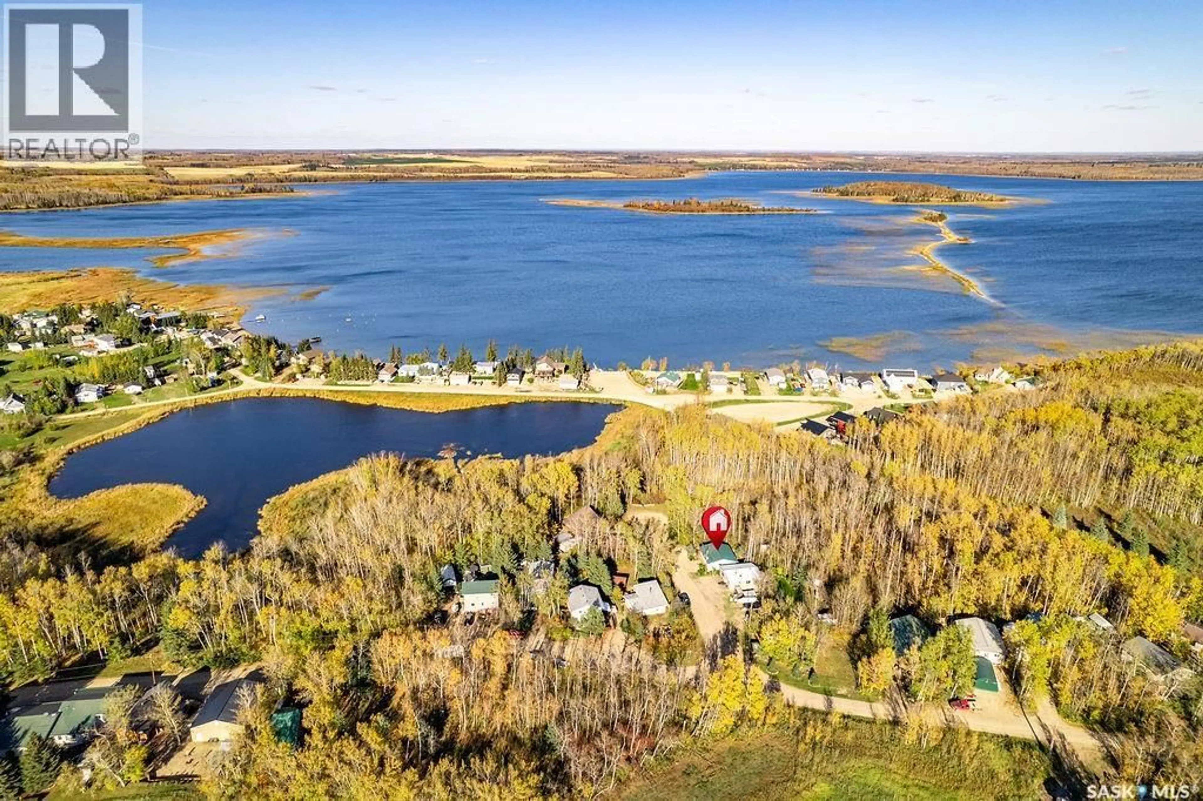 A pic from outside/outdoor area/front of a property/back of a property/a pic from drone, water/lake/river/ocean view for 509 POPLAR CRESCENT, Iroquois Lake Saskatchewan S0J1M0