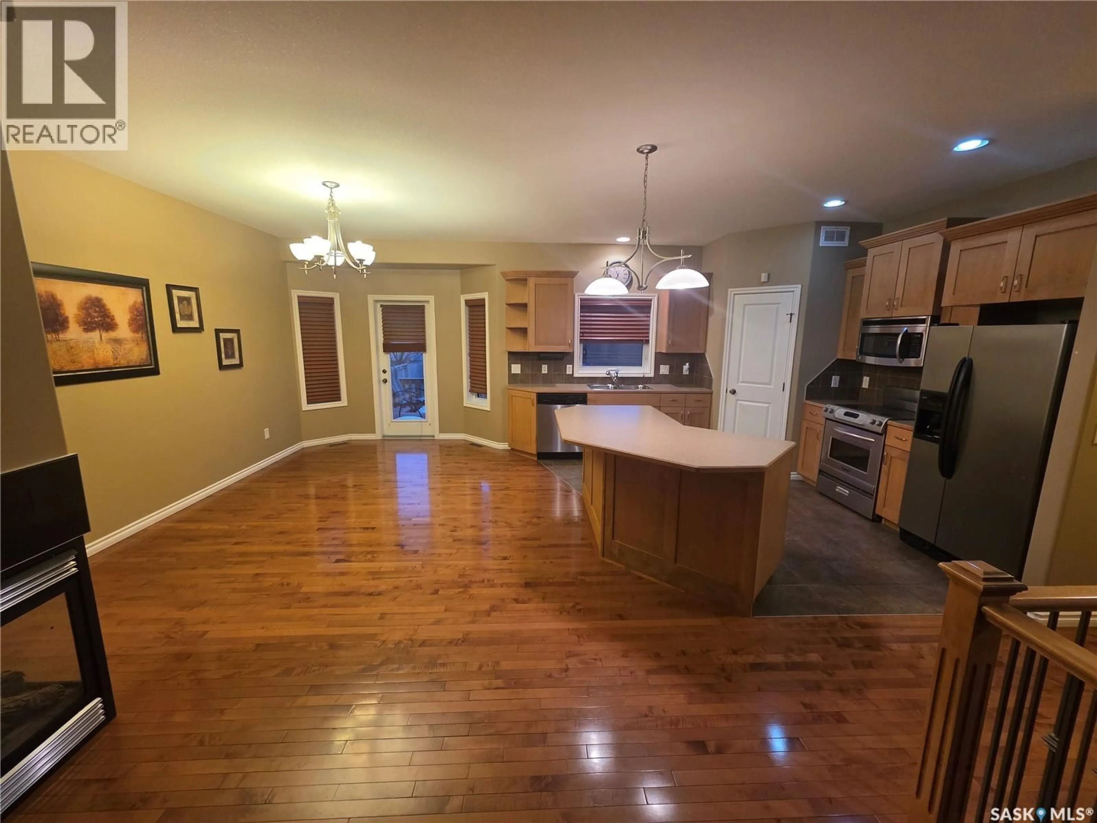 Open concept kitchen, wood/laminate floor for 315 BROOKSHIRE CRESCENT, Saskatoon Saskatchewan S7V1H2