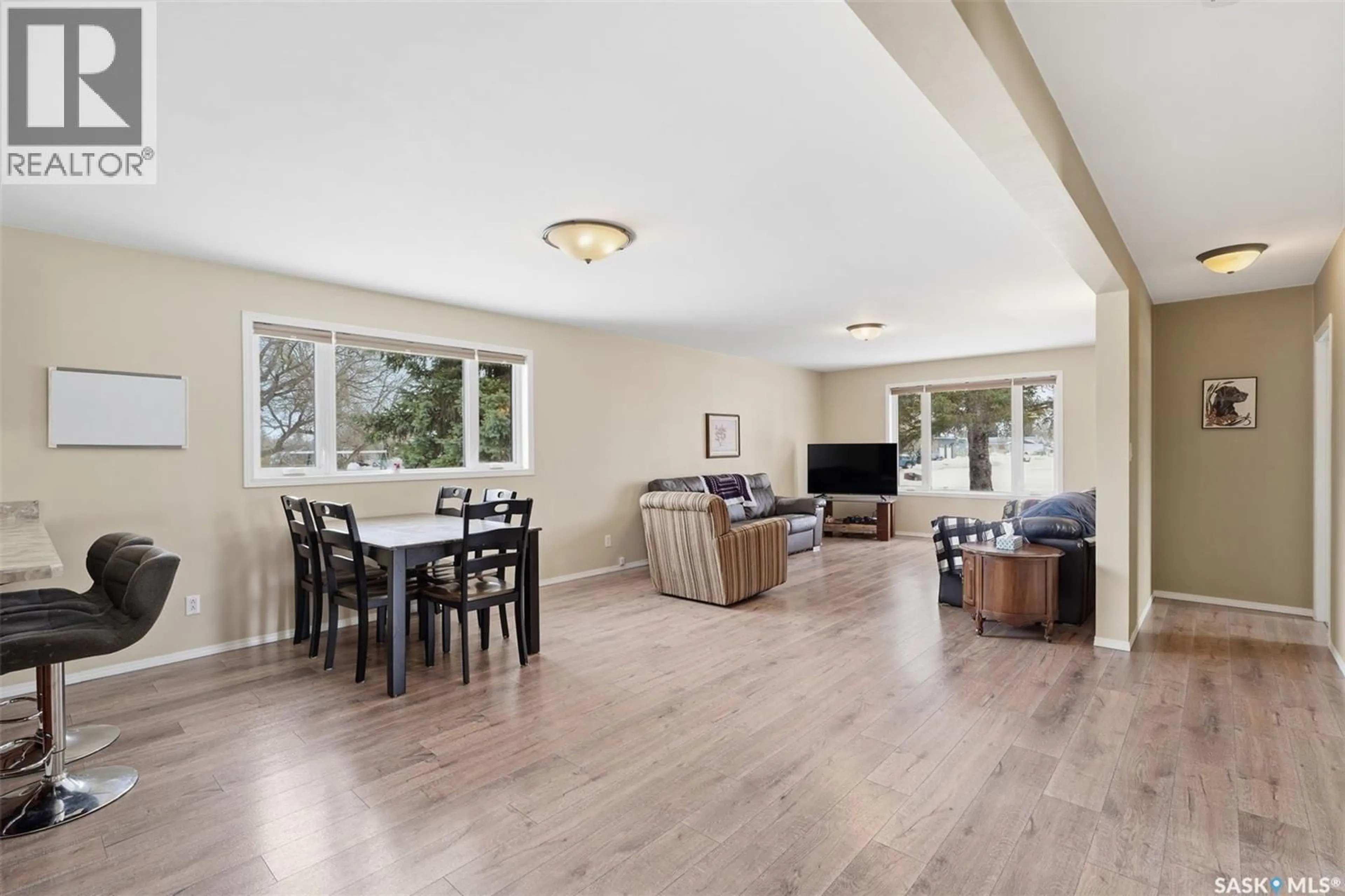 Living room with furniture, wood/laminate floor for 302 5TH AVENUE, Watrous Saskatchewan S0K4T0