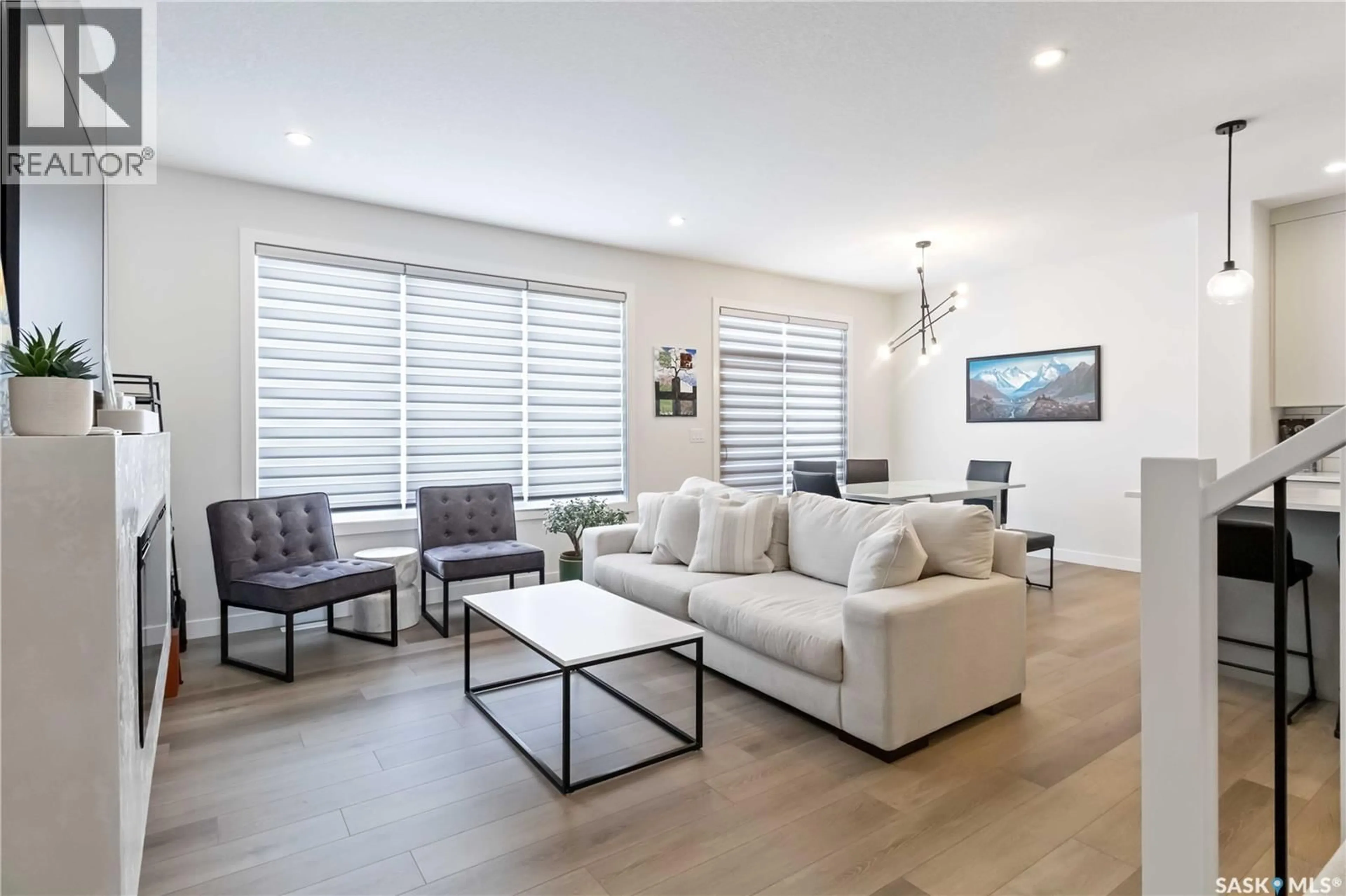 Living room with furniture, wood/laminate floor for 155 KEITH WAY, Saskatoon Saskatchewan S7V0X9