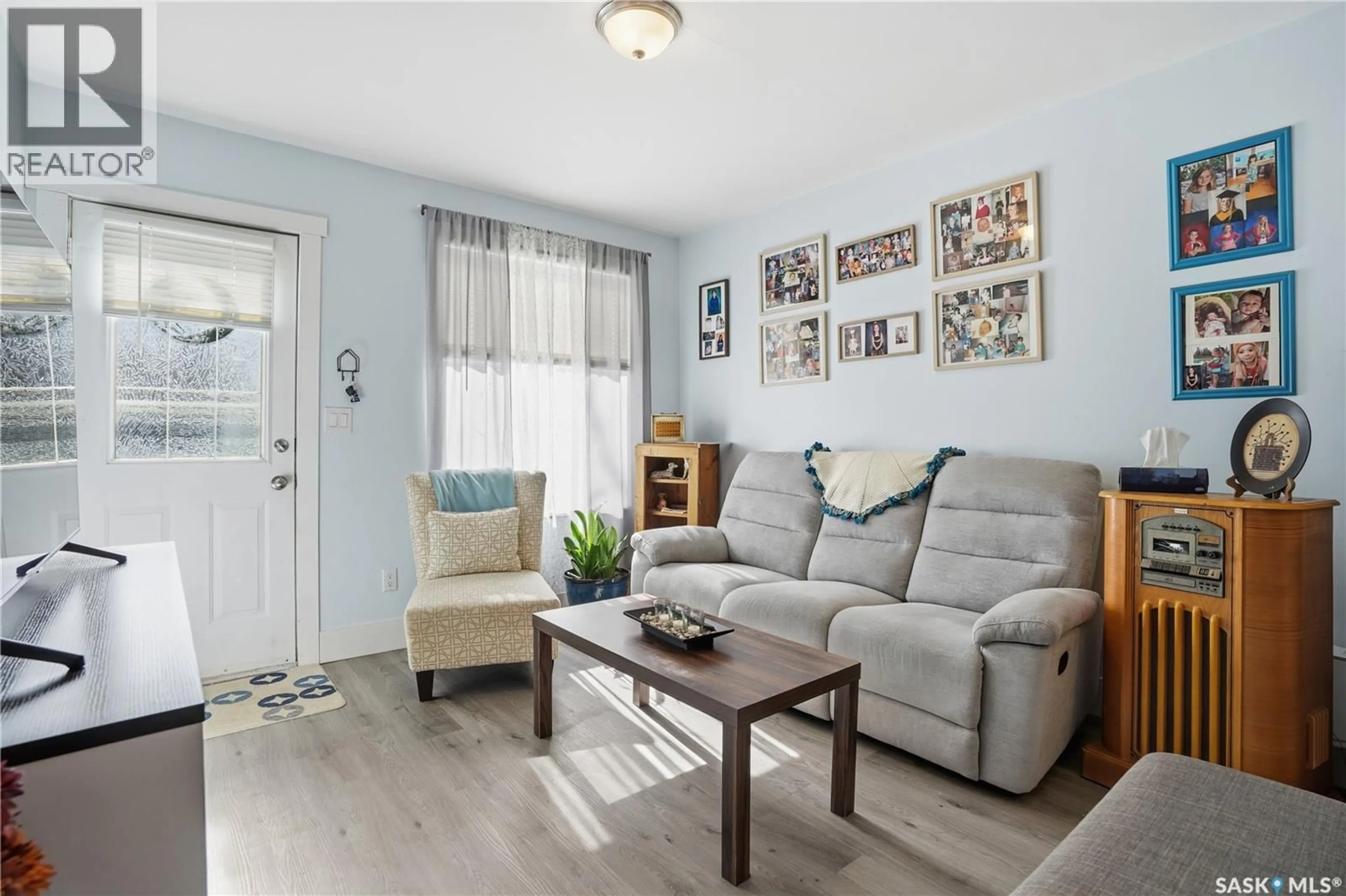 Living room with furniture, wood/laminate floor for 44 LILLOOET STREET, Moose Jaw Saskatchewan S6H4Y5