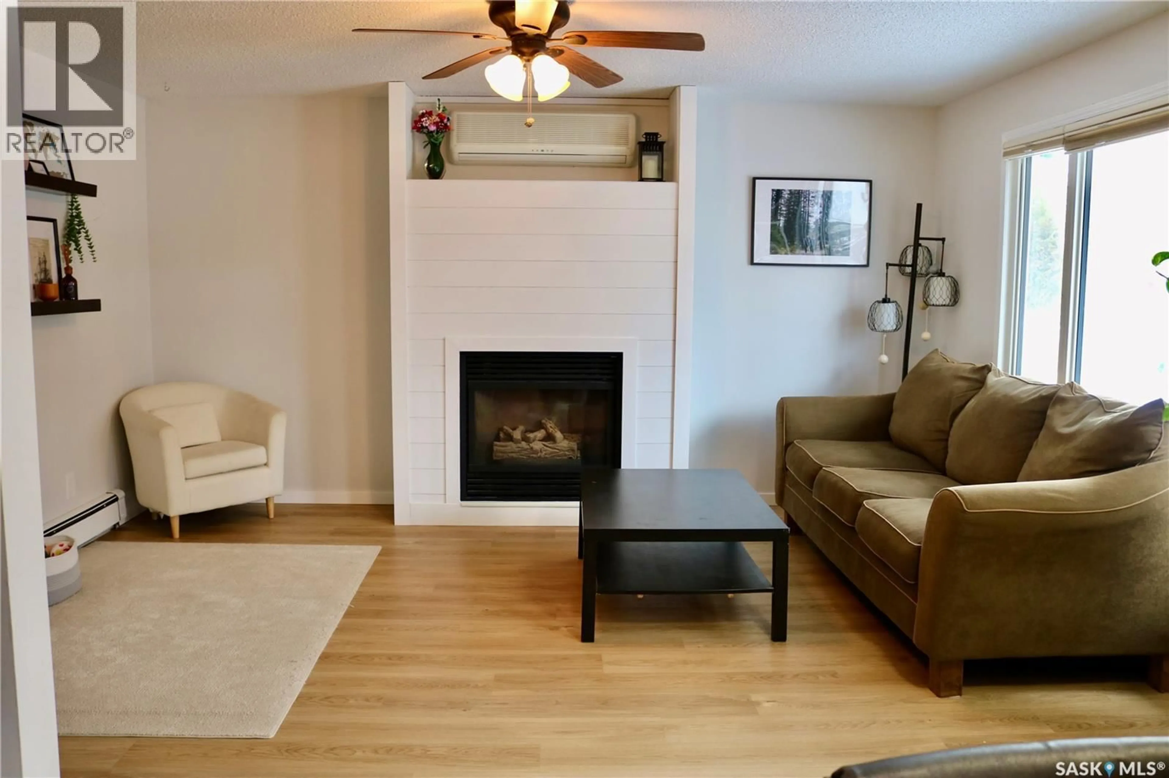 Living room with furniture, wood/laminate floor for 812 MCNAUGHTON STREET, Moosomin Saskatchewan S0G3N0