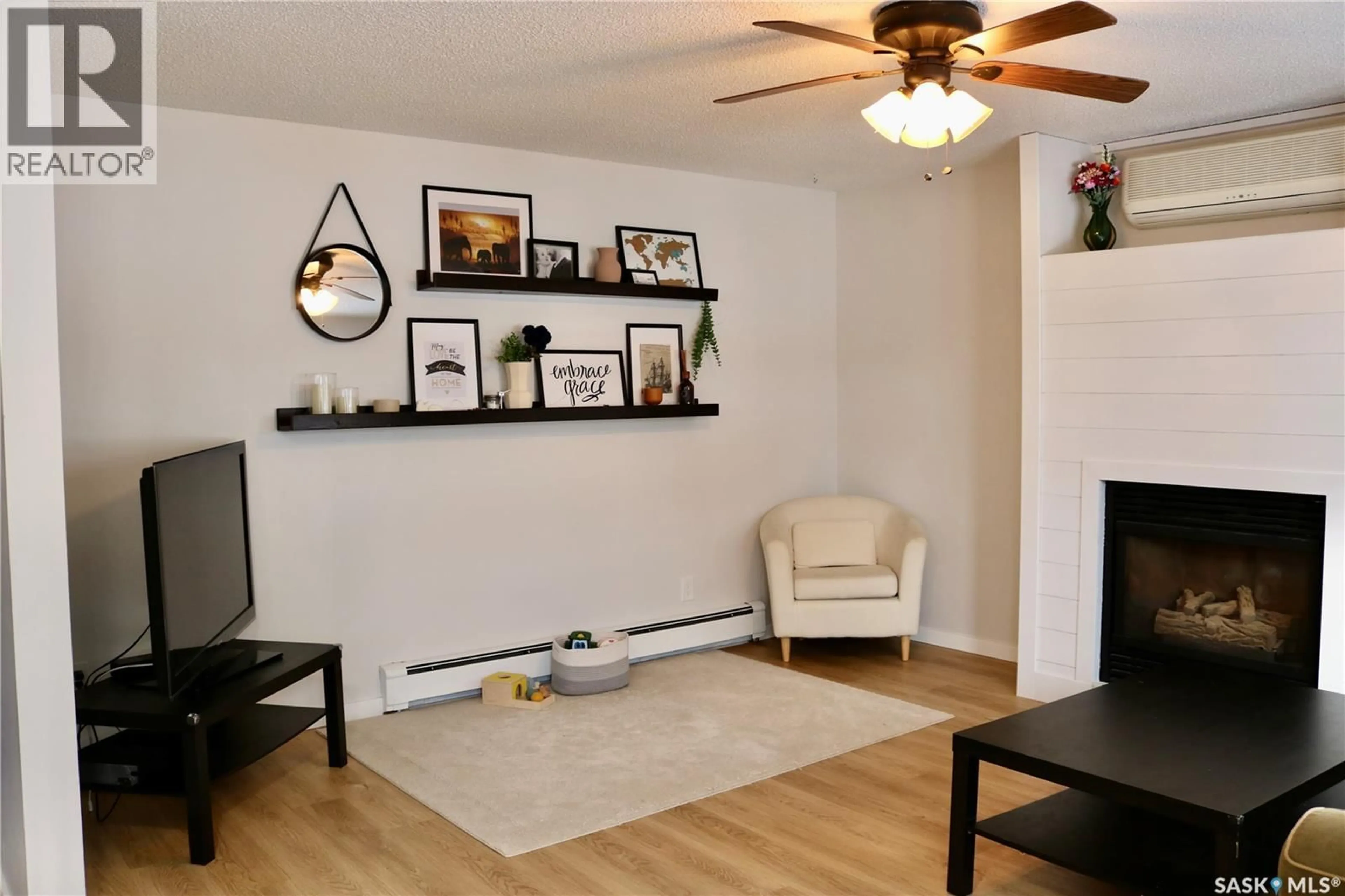 Living room with furniture, wood/laminate floor for 812 MCNAUGHTON STREET, Moosomin Saskatchewan S0G3N0