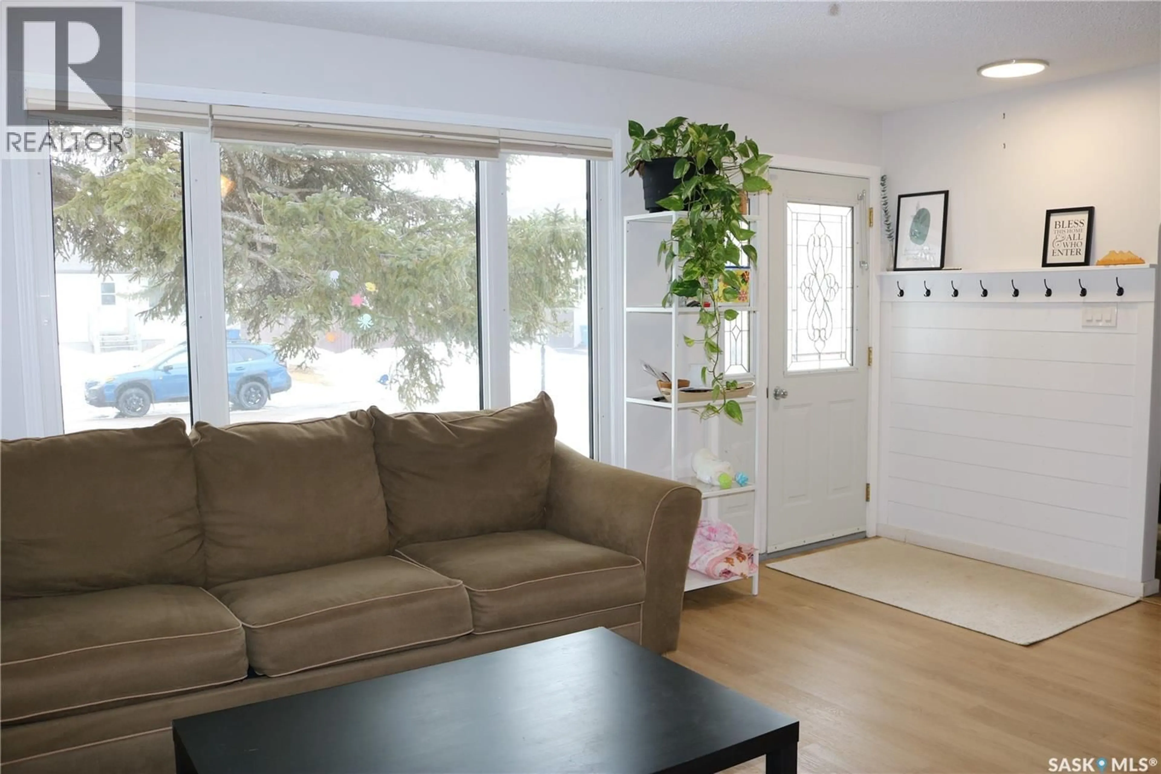 Living room with furniture, wood/laminate floor for 812 MCNAUGHTON STREET, Moosomin Saskatchewan S0G3N0