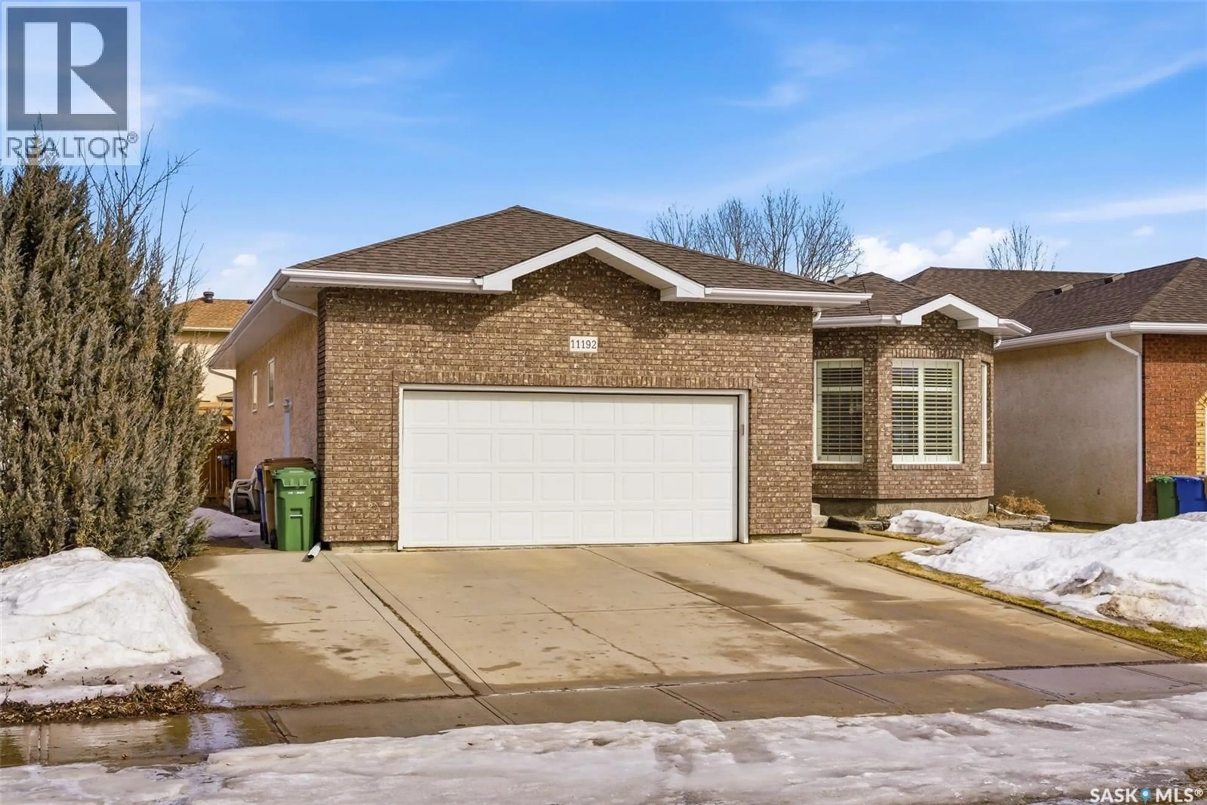 Home with brick exterior material, street for 11192 WASCANA MEADOWS, Regina Saskatchewan S4V2W2
