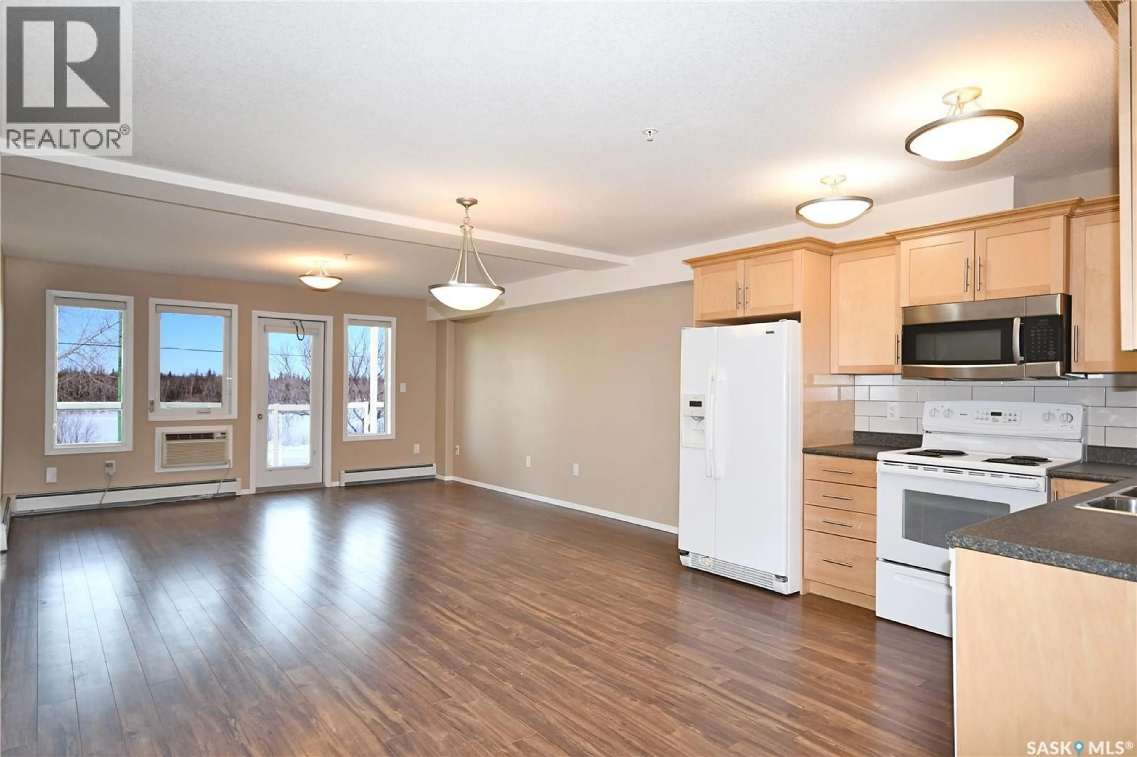 Open concept kitchen, wood/laminate floor for 202 395 RIVER STREET E, Prince Albert Saskatchewan S6V0A3