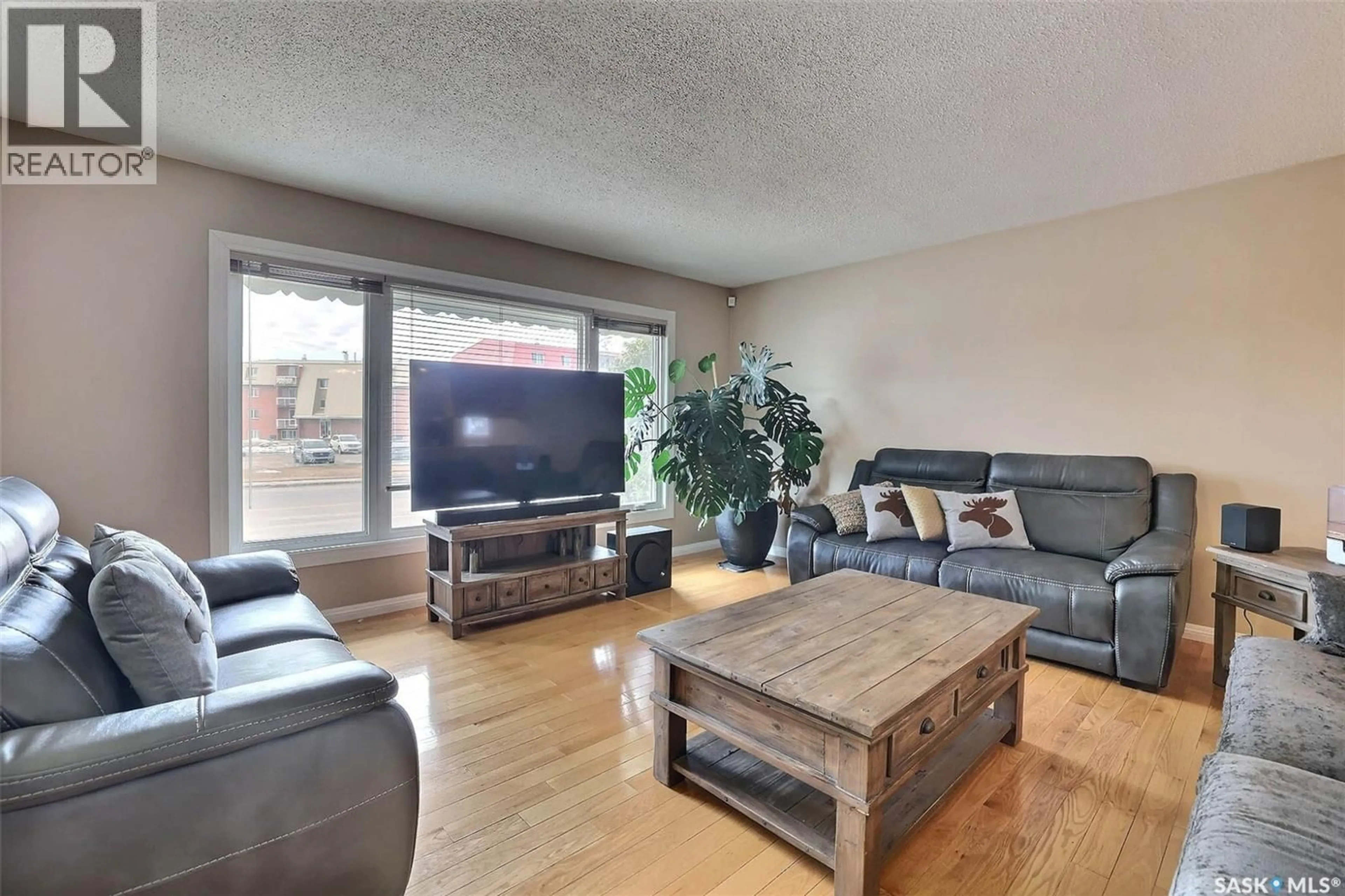 Living room with furniture, wood/laminate floor for 5450 SHERWOOD DRIVE, Regina Saskatchewan S4R5M3