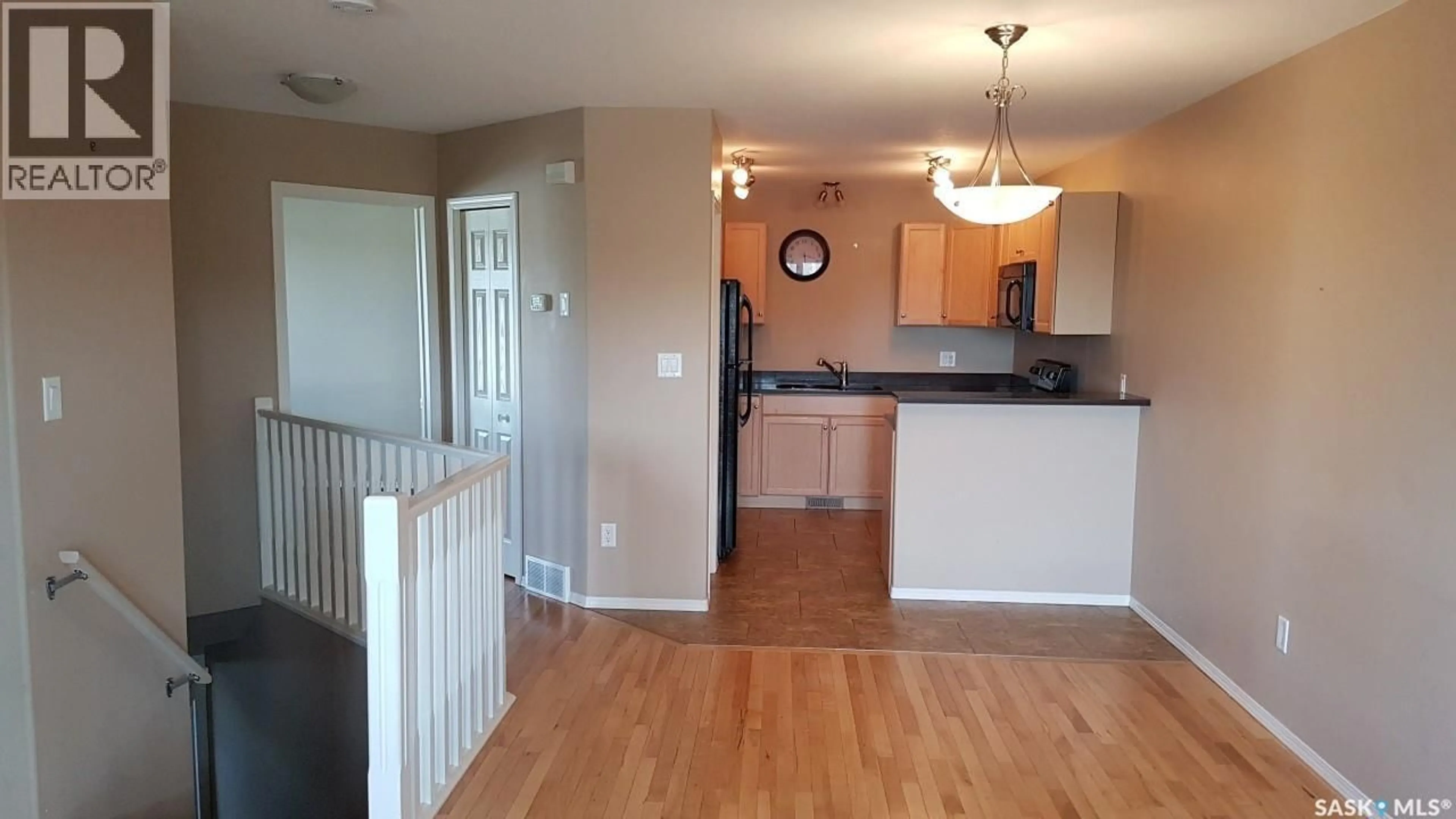 Open concept kitchen, wood/laminate floor for 1 201 CARLYLE AVENUE, Carlyle Saskatchewan S0C0R0