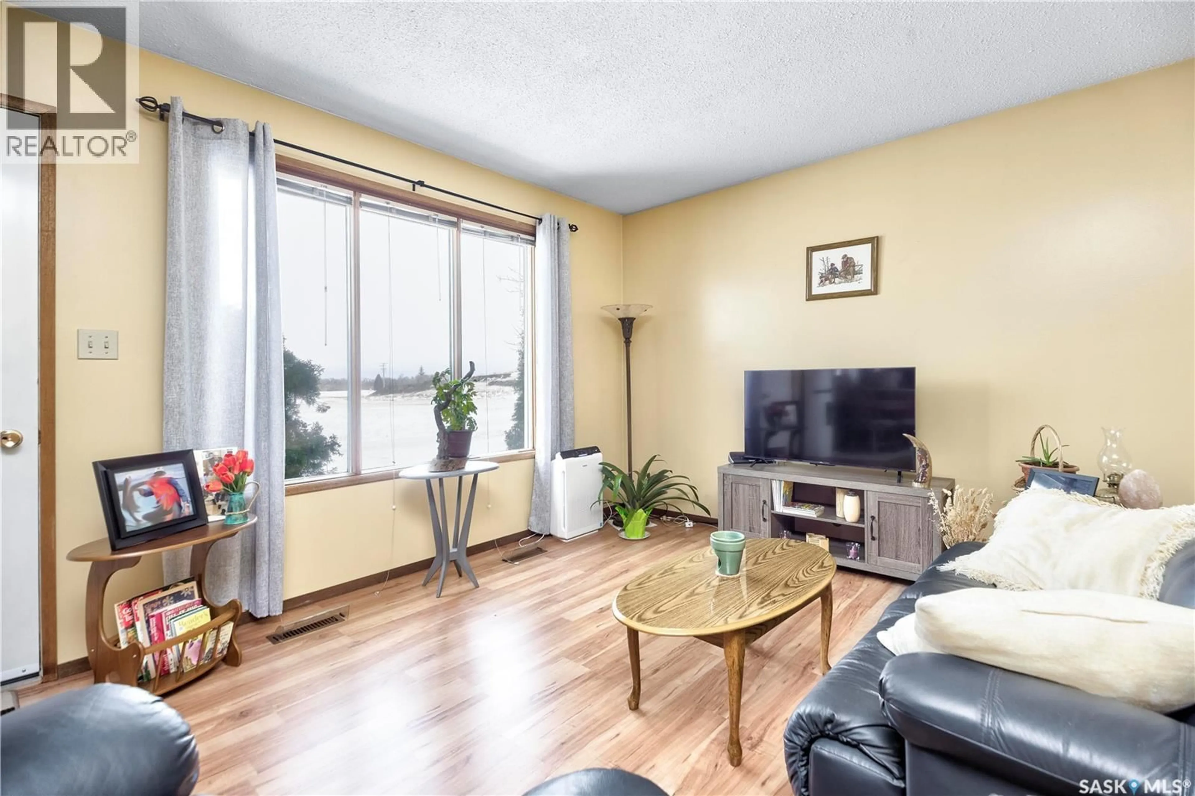 Living room with furniture, wood/laminate floor for 325 7TH STREET, Duck Lake Saskatchewan S0K1J0