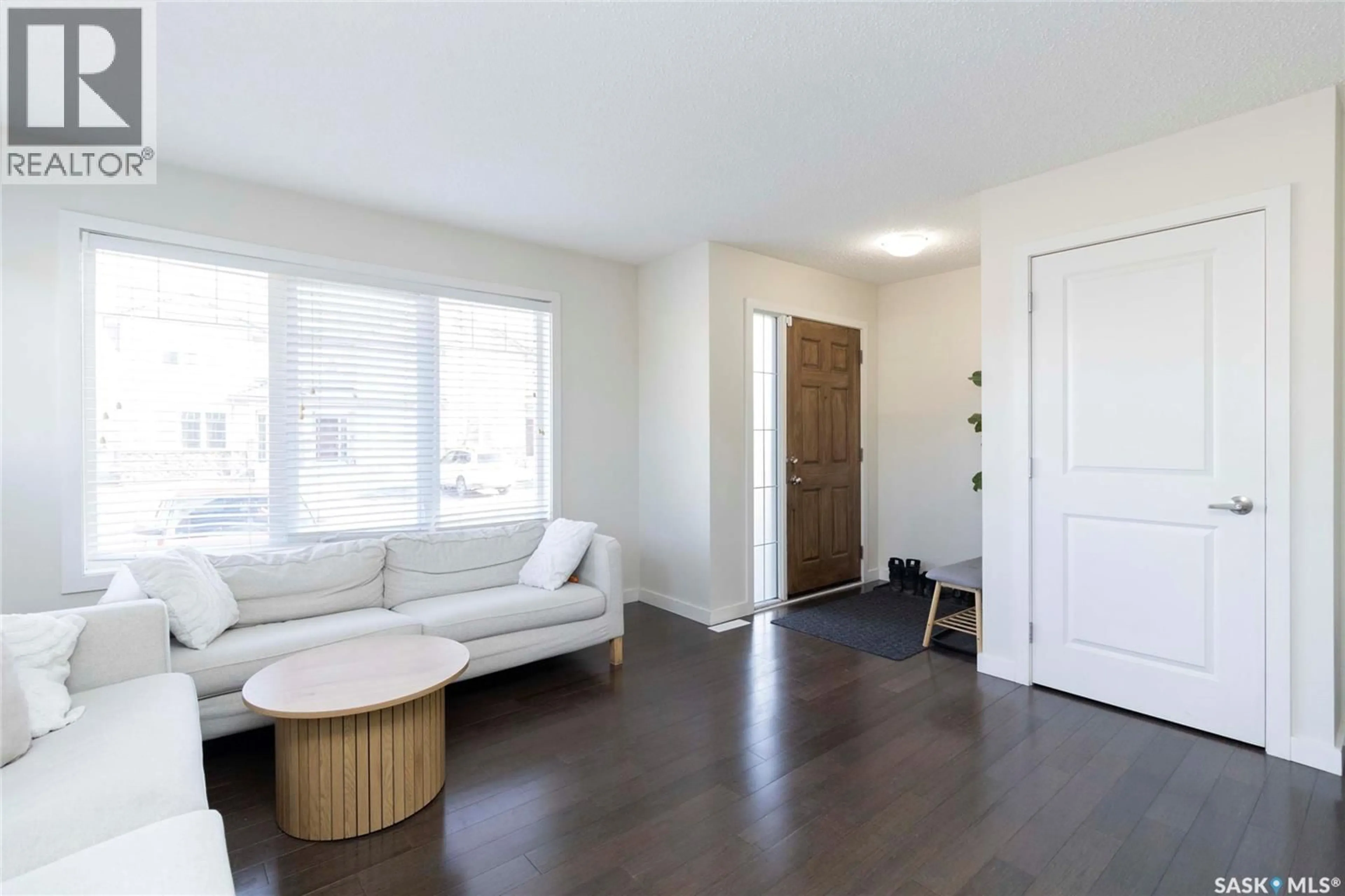 Living room with furniture, wood/laminate floor for 125 135 ASHWORTH CRESCENT, Saskatoon Saskatchewan S7T0N1