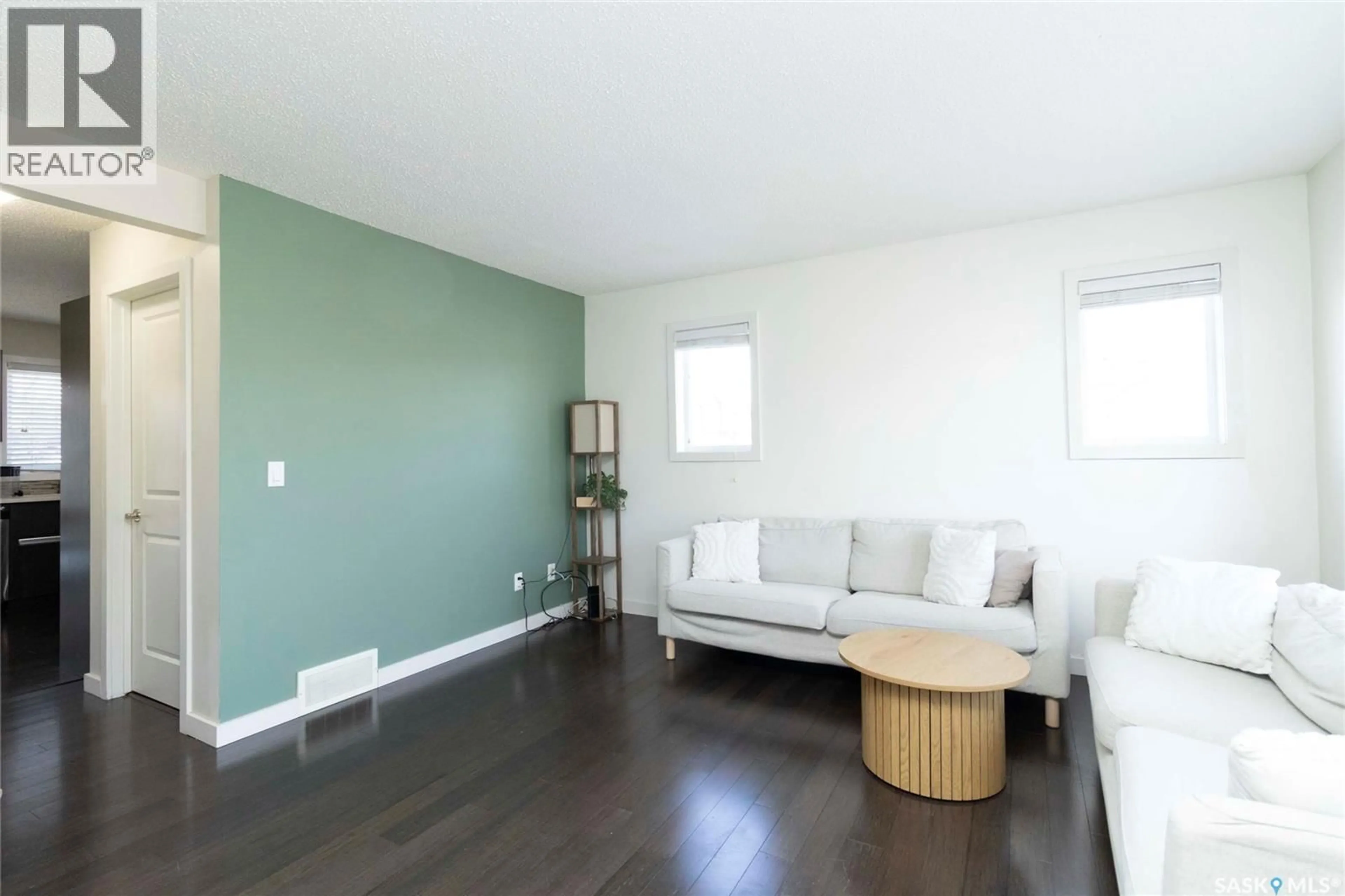 Living room with furniture, wood/laminate floor for 125 135 ASHWORTH CRESCENT, Saskatoon Saskatchewan S7T0N1