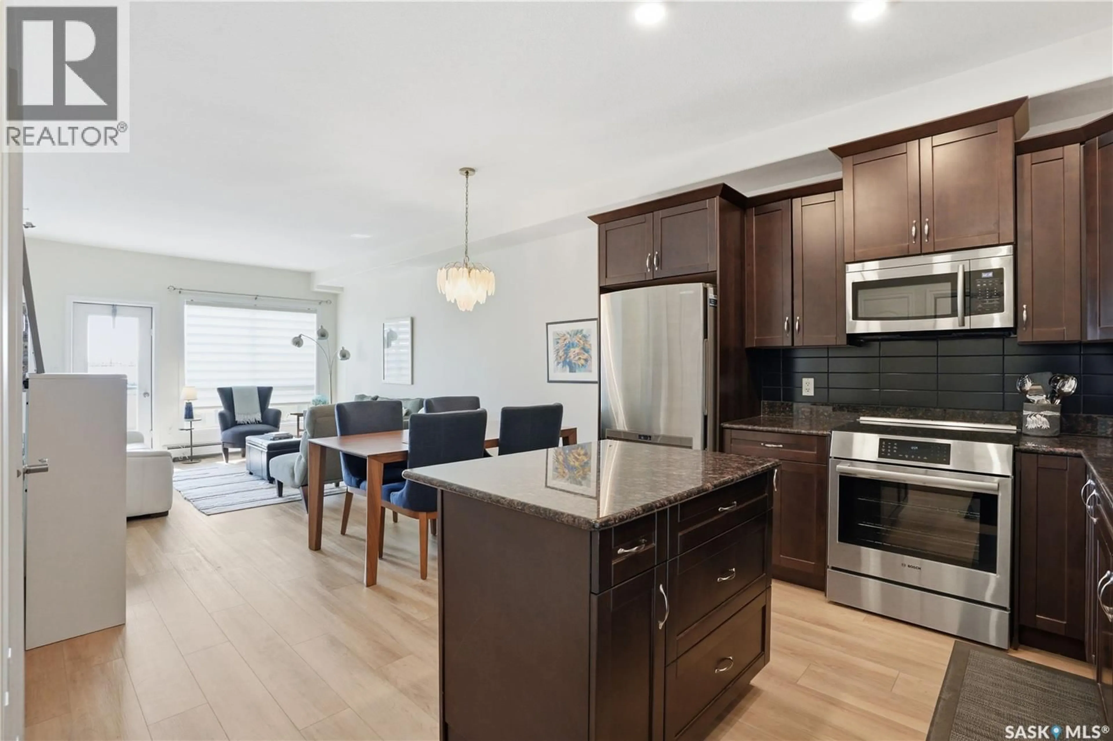 Open concept kitchen, wood/laminate floor for 324 2710 MAIN STREET, Saskatoon Saskatchewan S7H0M3